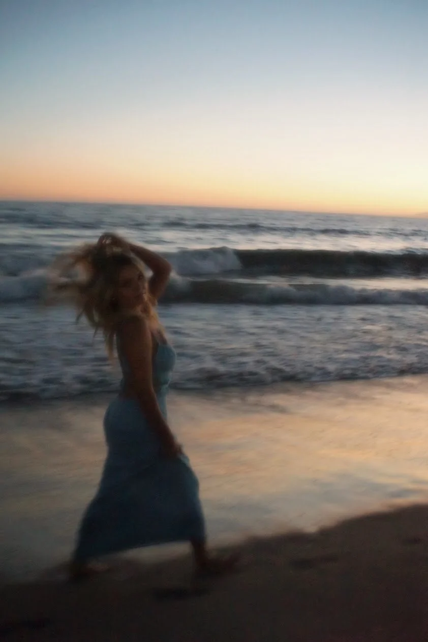woman walking along shoreline cinematic beach photography Los Angeles