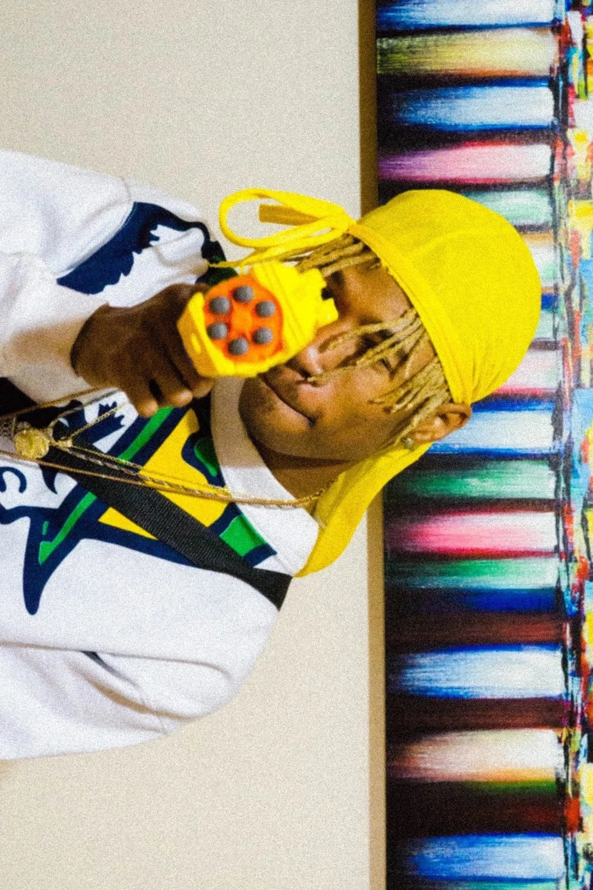 man wearing yellow drug with colorful backdrop creative portrait photography Los Angeles