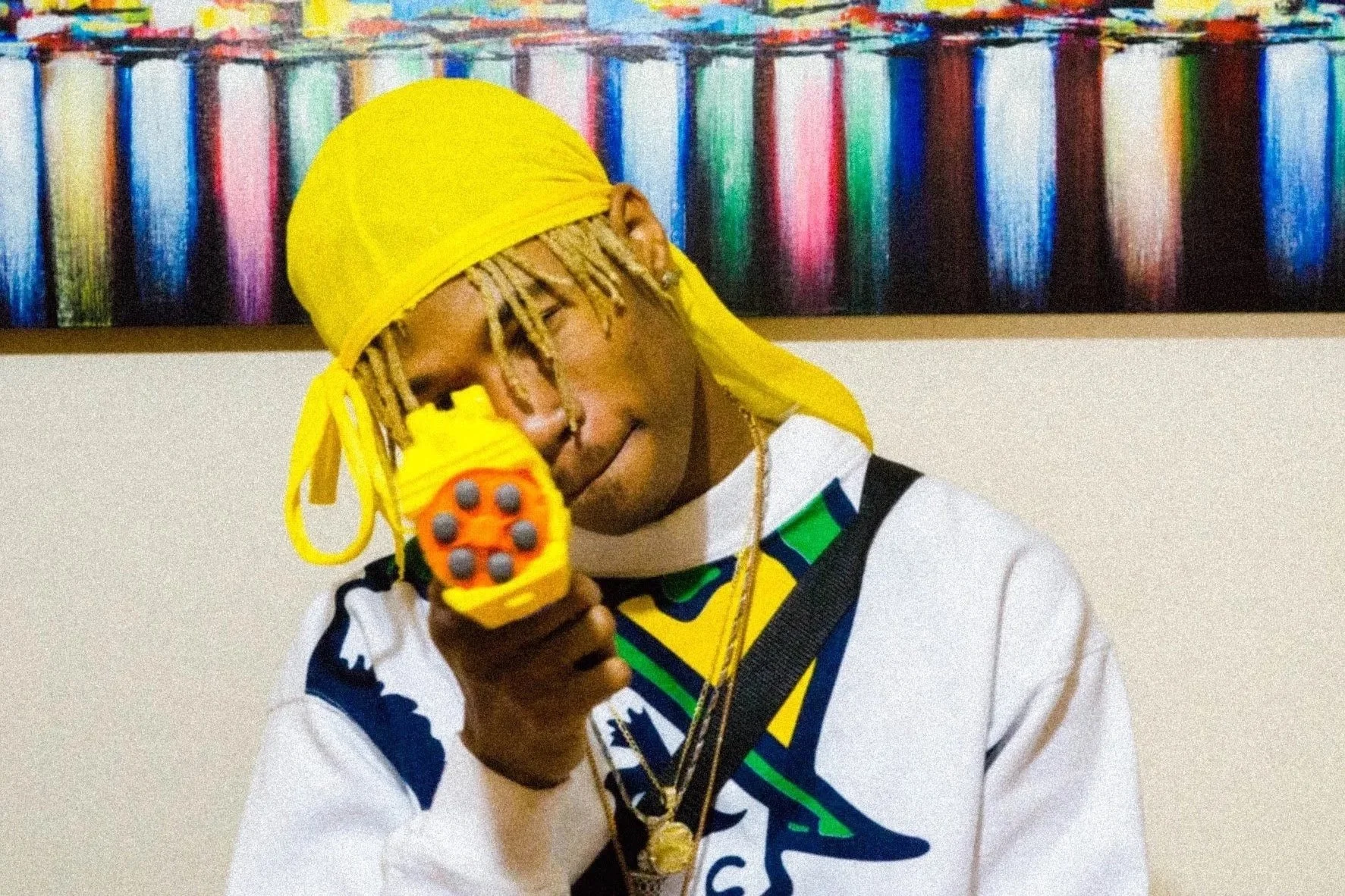 man wearing yellow drug with colorful backdrop creative portrait photography Los Angeles