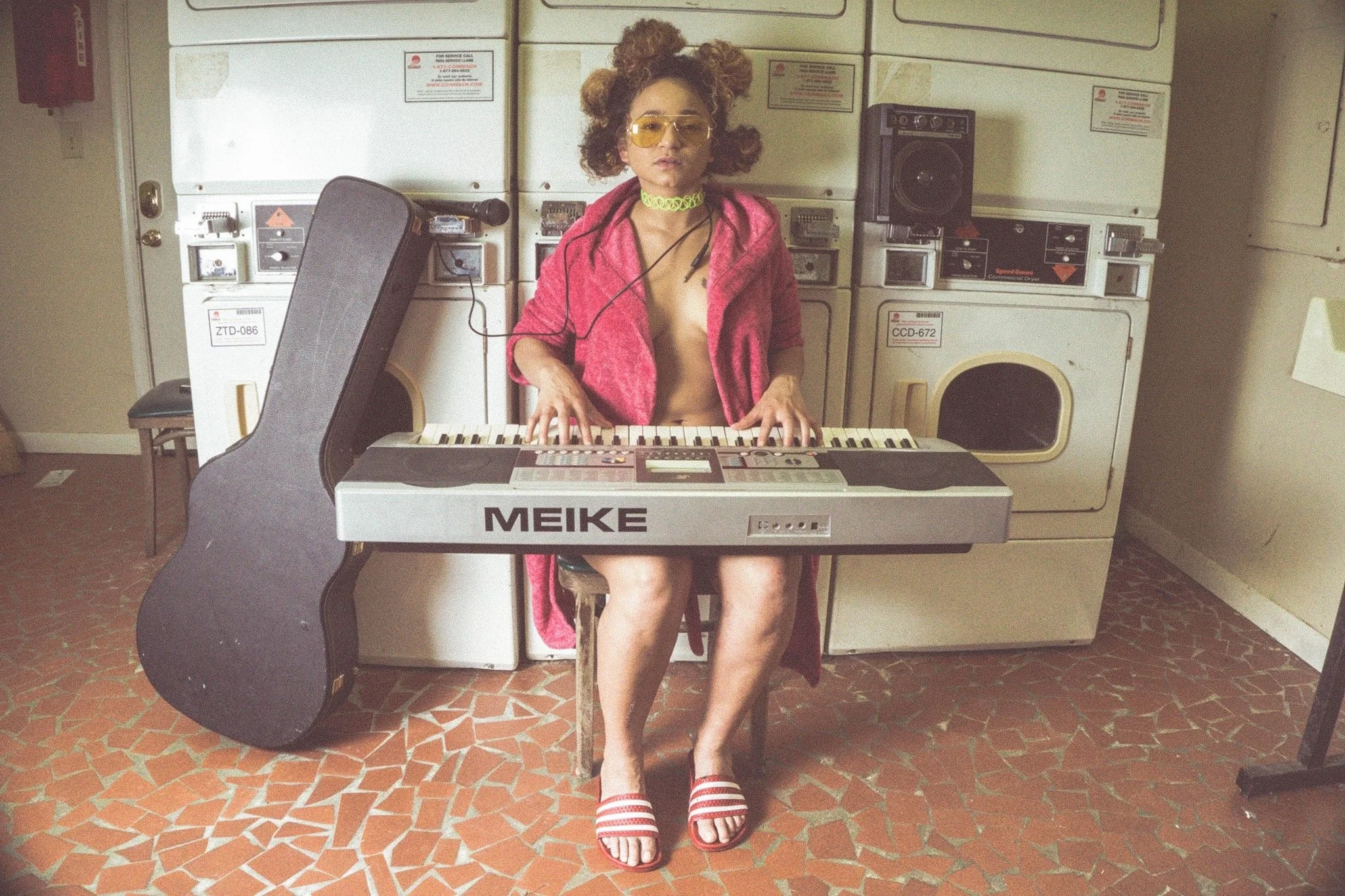 musician woman sitting in laundry mat full body portrait photography Los Angeles