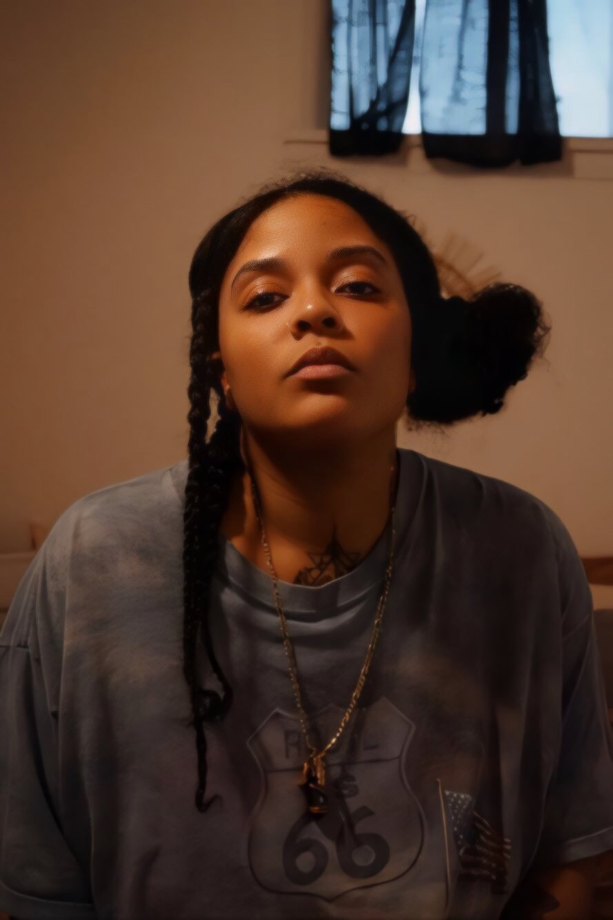 close up portrait of woman with braids in warm indoor lighting cinematic style