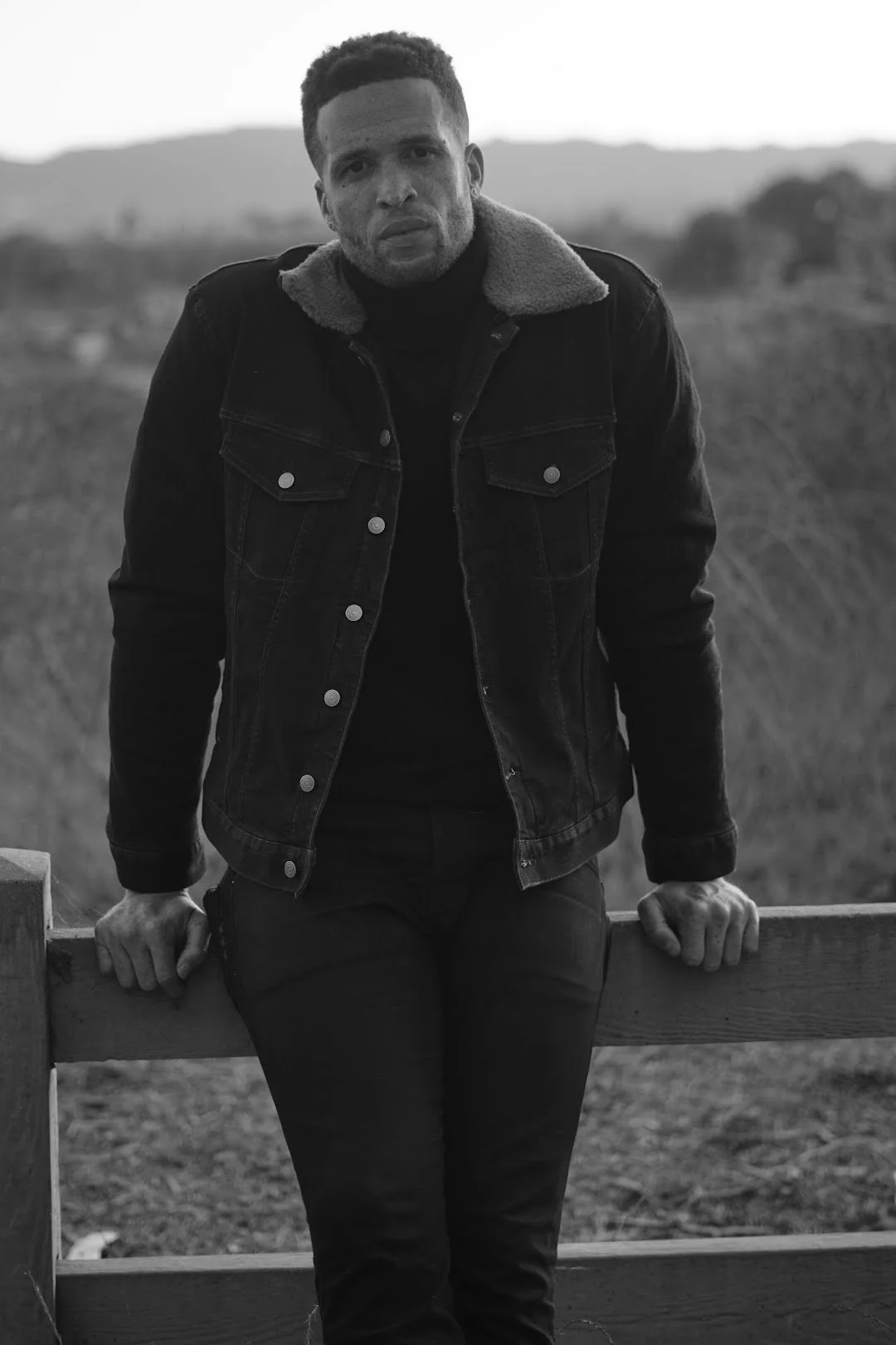 man standing in black outfit black and white portrait photography Los Angeles