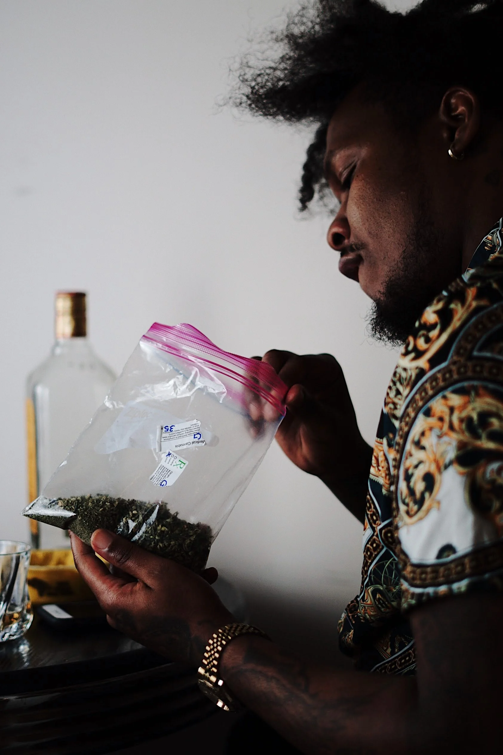 man holding plastic bag that has cannabis inside candid lifestyle photography Los Angeles