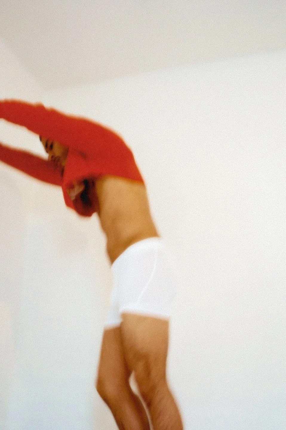 man adjusting red Calvin Klein crop top sweater lifestyle detail portrait photography Los Angeles