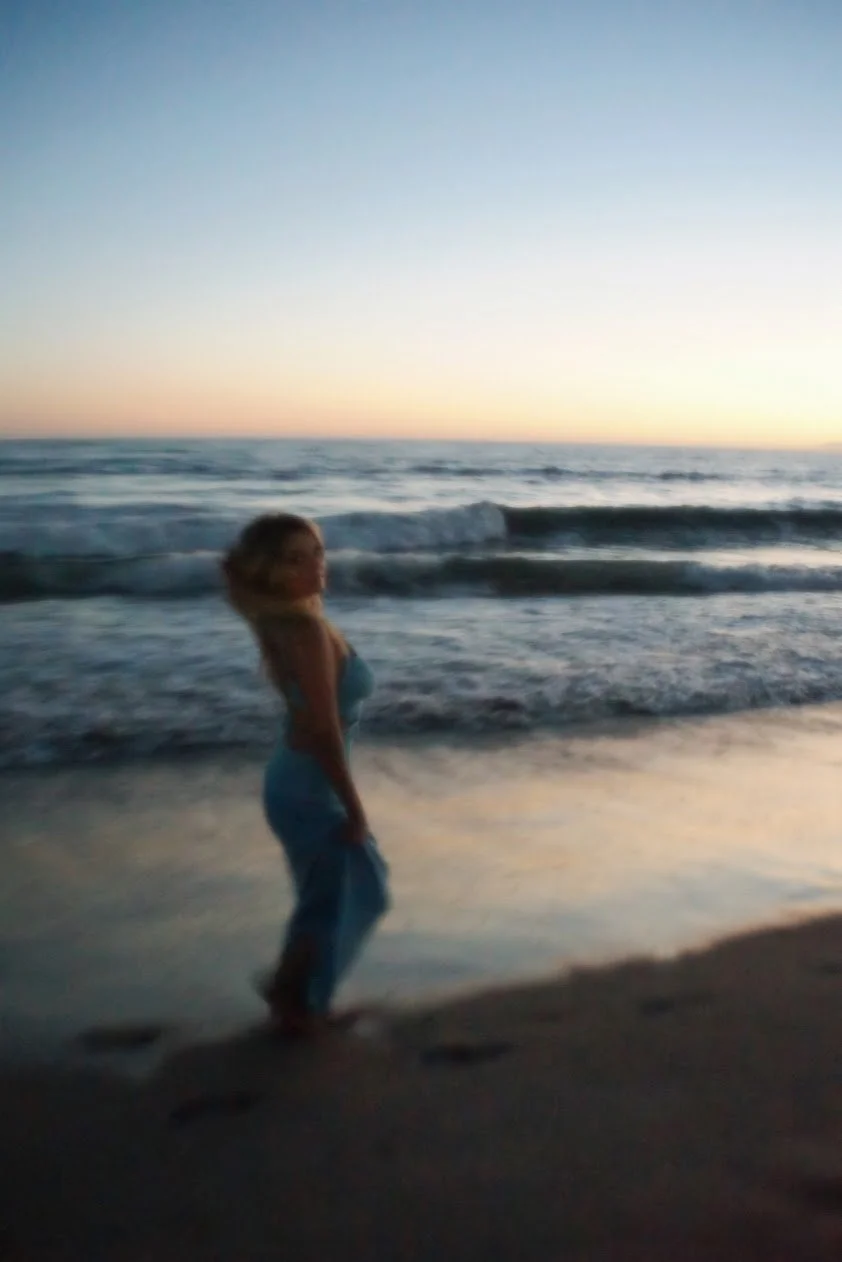 woman standing by ocean waves during sunset cinematic photography Los Angeles