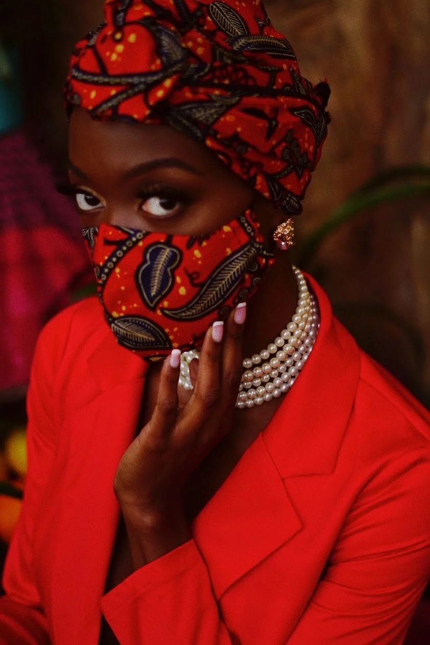 woman wearing red outfit and headwrap looking at camera editorial portrait photography Los Angeles