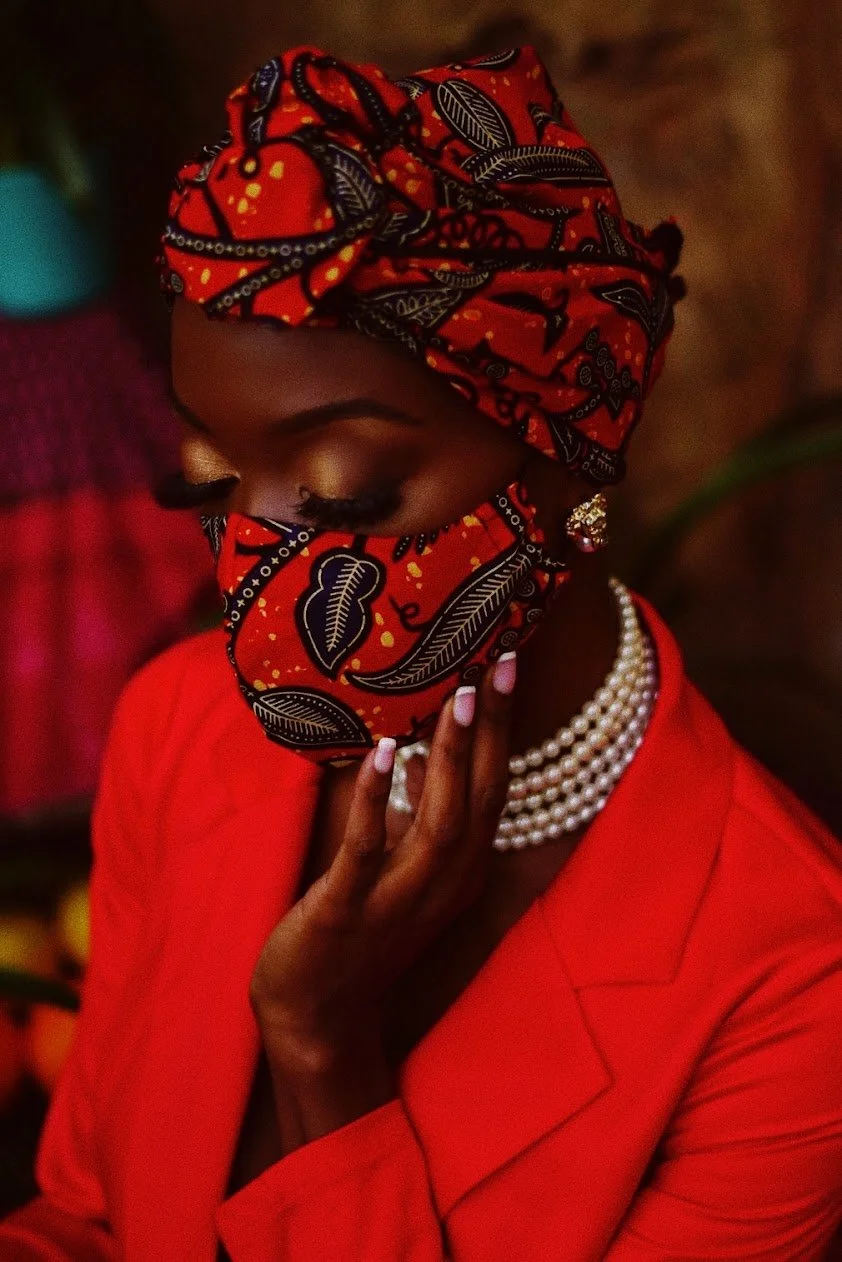woman in red outfit and headwrap looking down cinematic editorial portrait photography Los Angeles