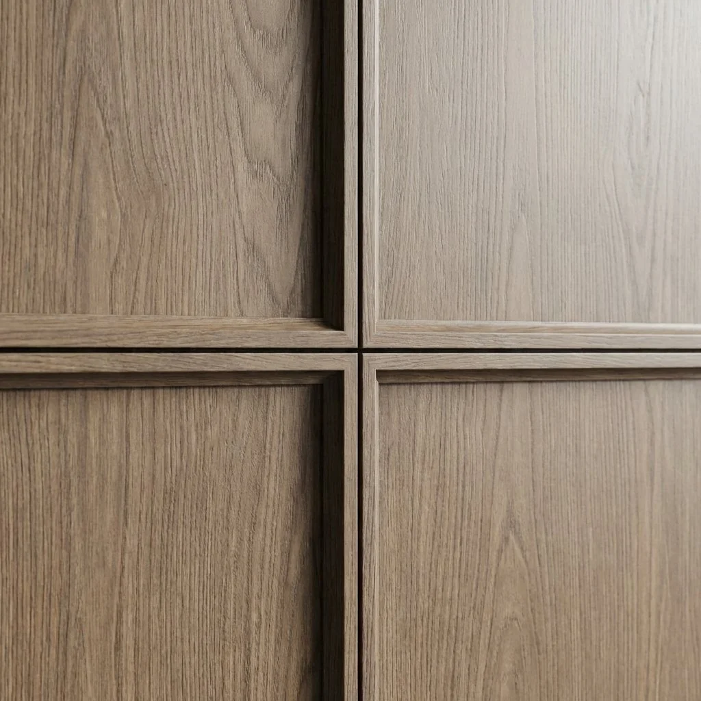Close-up of four wooden cabinet doors with a natural finish.