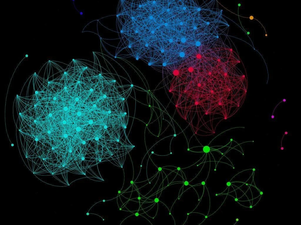 Colorful digital network illustration with interconnected nodes forming clusters on a black background
