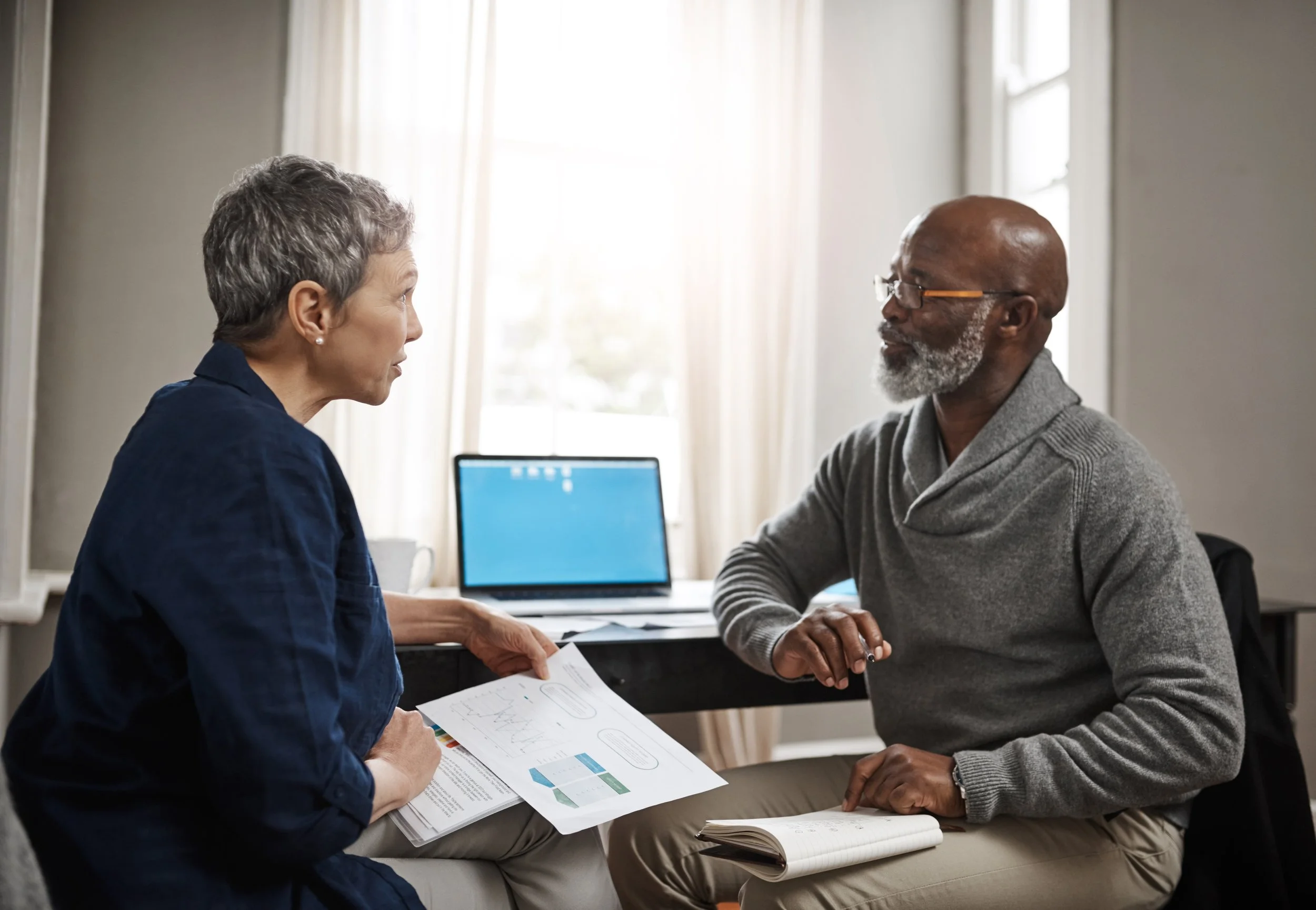 Retired man reviewing a Medicare Supplement plan document with a licensed advisor.