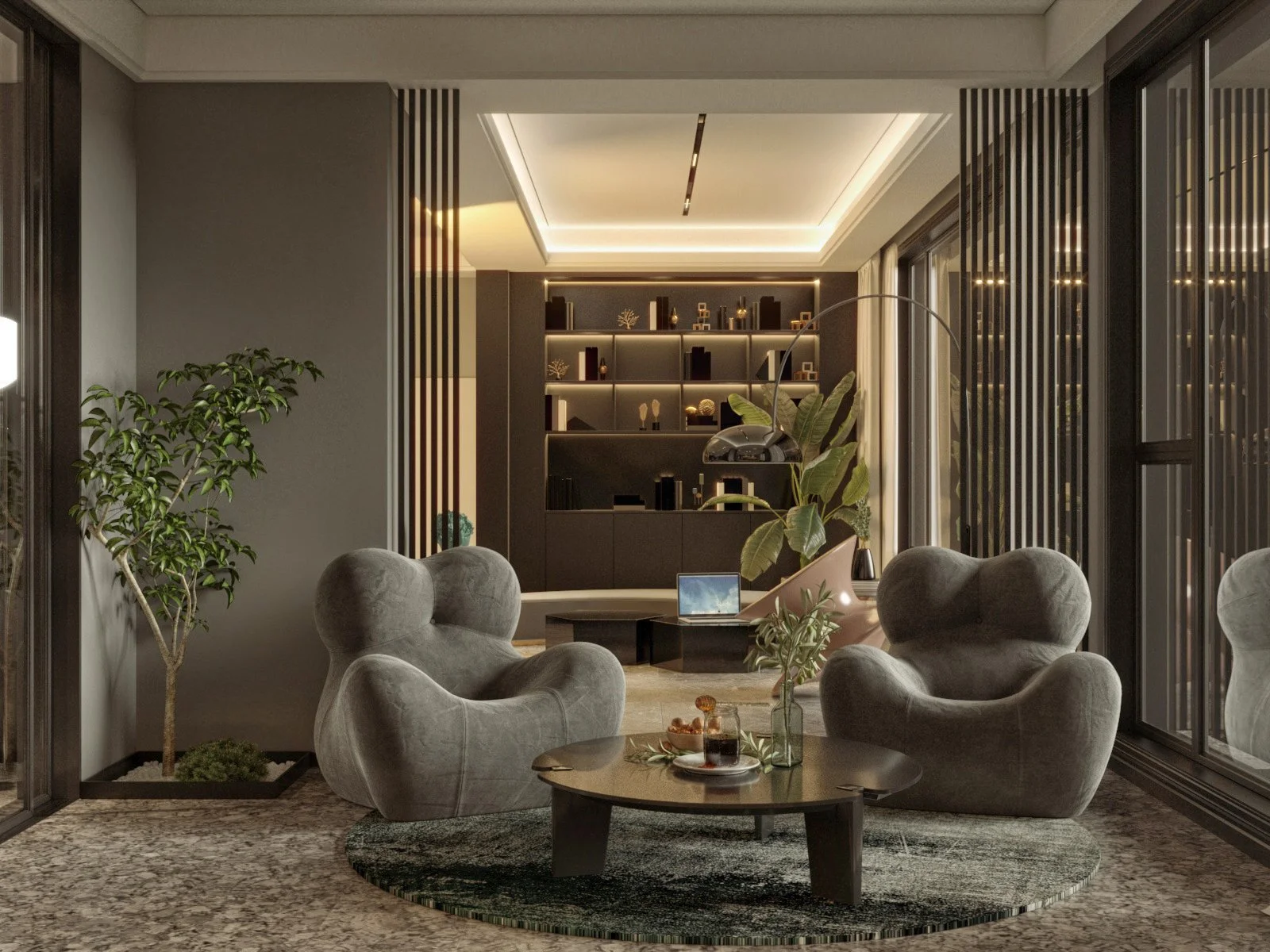 Modern living room with two gray armchairs, a small round coffee table with drinks, a tall plant, and a built-in dark bookshelf with decorative objects, illuminated by ambient lighting.