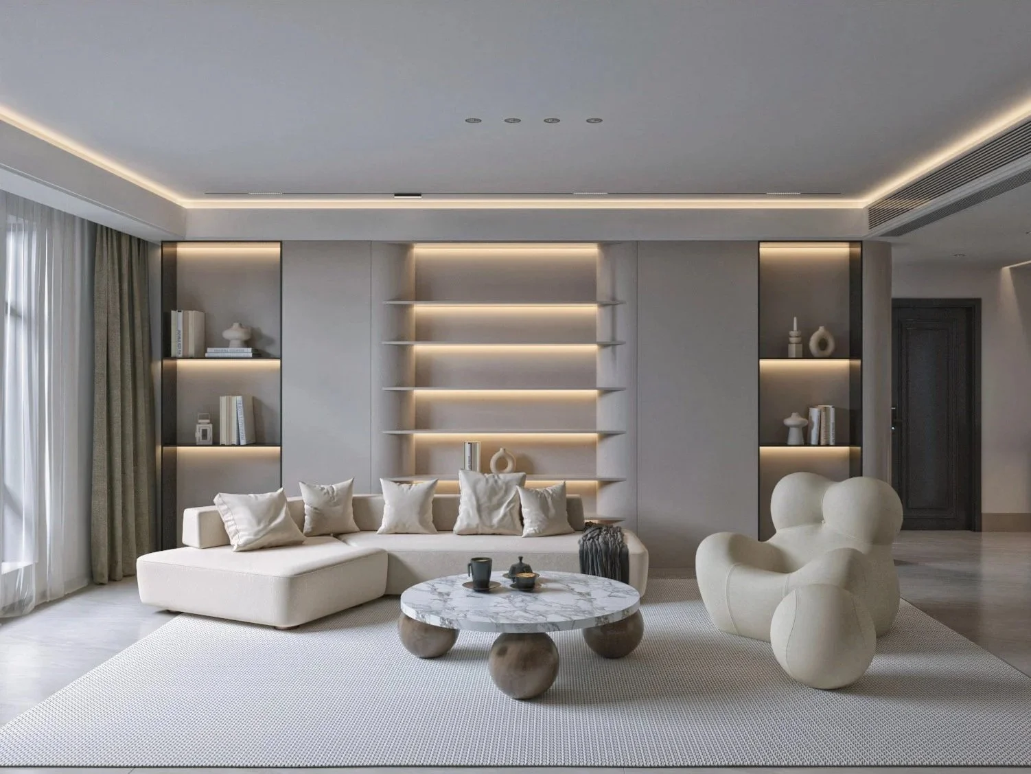 Modern living room with a large white sofa, decorative cushions, a marble coffee table, and unique beige armchair, with built-in shelving and soft lighting on the back wall, and a window with curtains.