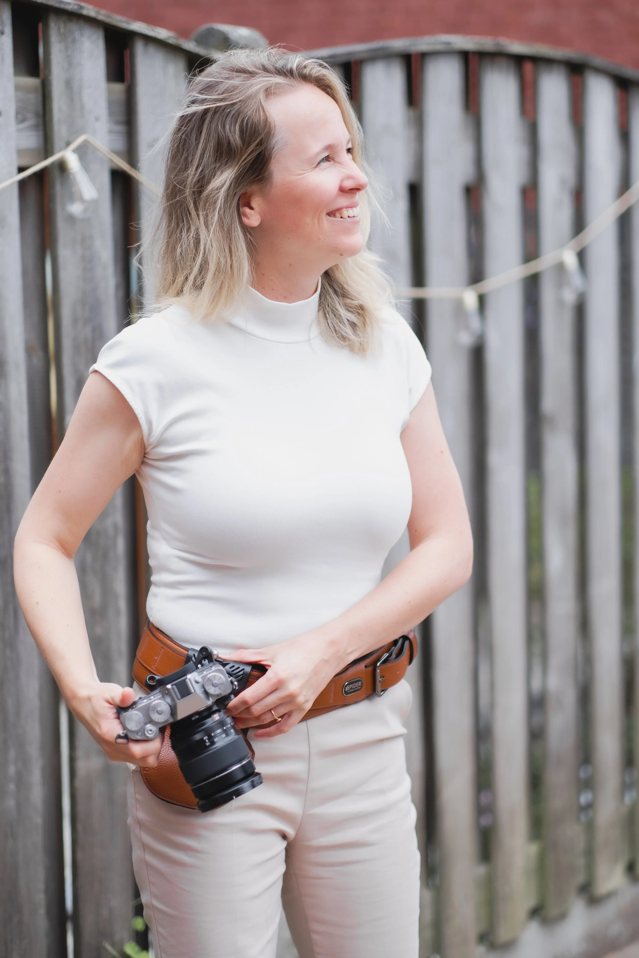 Nikol Pecka, one of the founders of Stardust Media Studio standing with her Fuji Camera ready for photography.