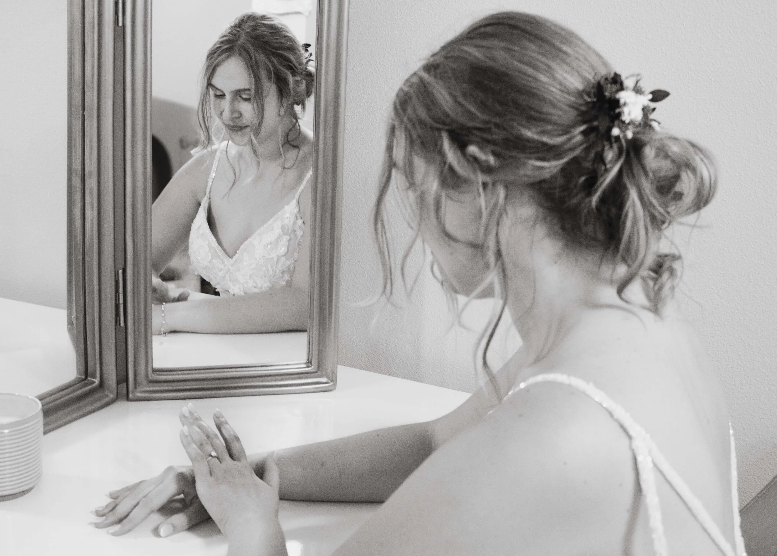 Wedding photograph of a bride looking in the mirror.