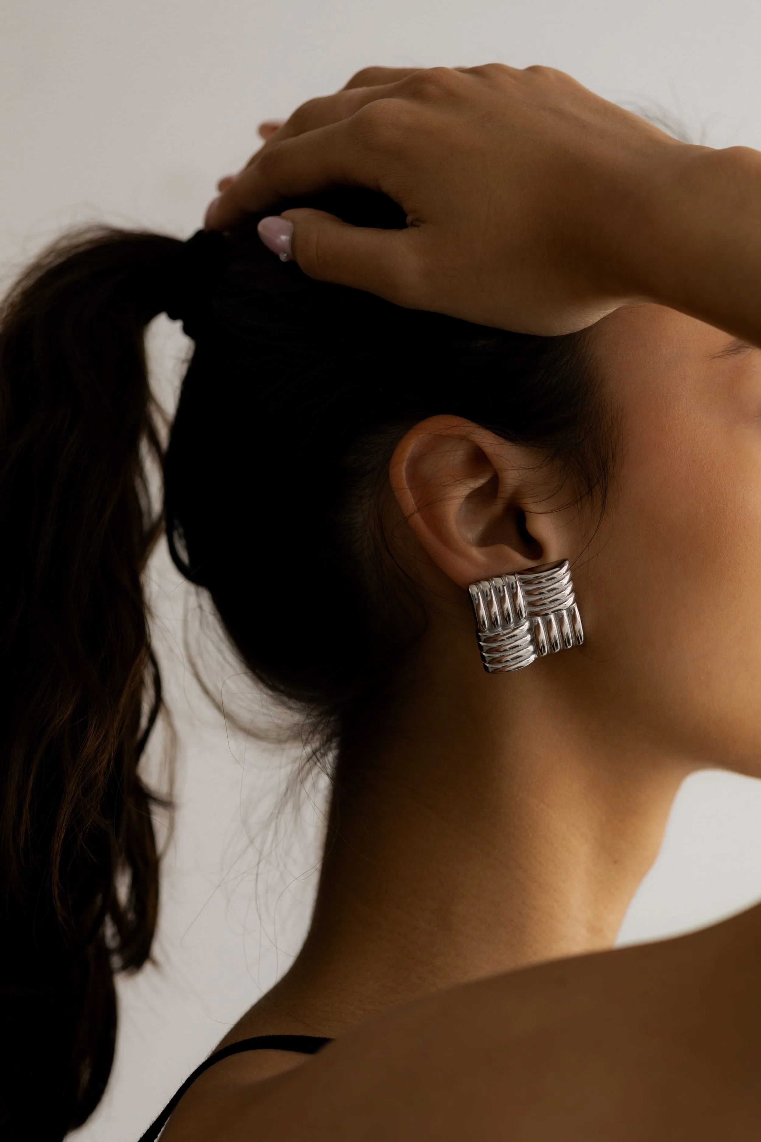 Person holding the back of their head representing anxiety and chronic worry.