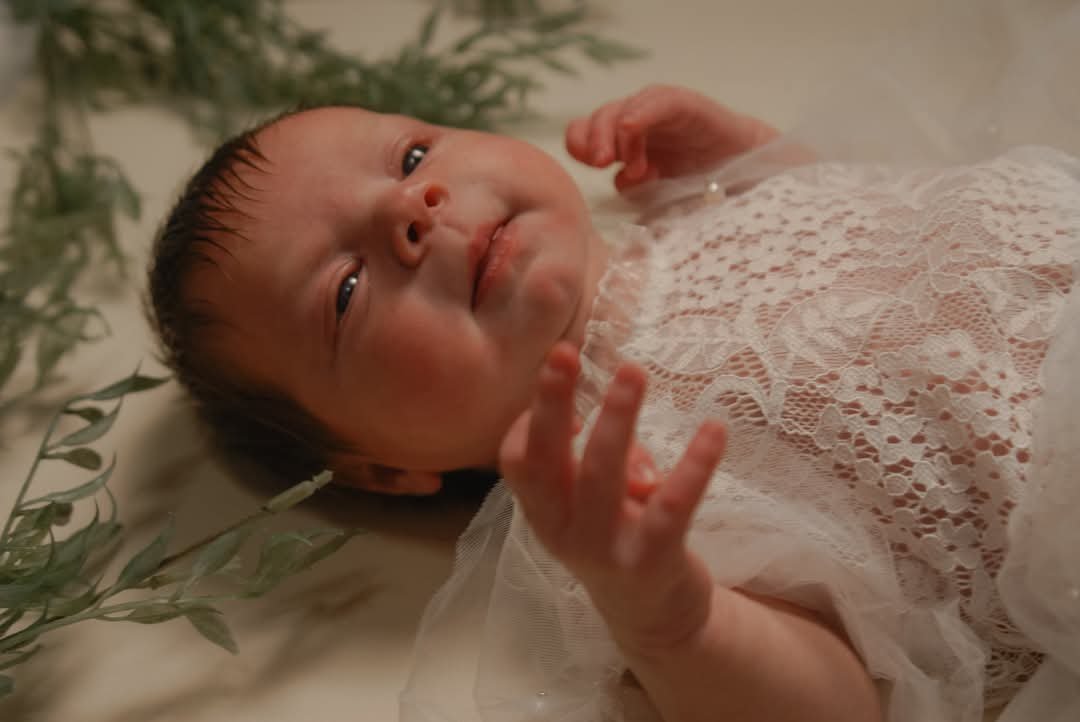 Newborn baby photography session featuring a baby girl in a lace outfit, photographed by Faith K Photography in Conway, South Carolina.