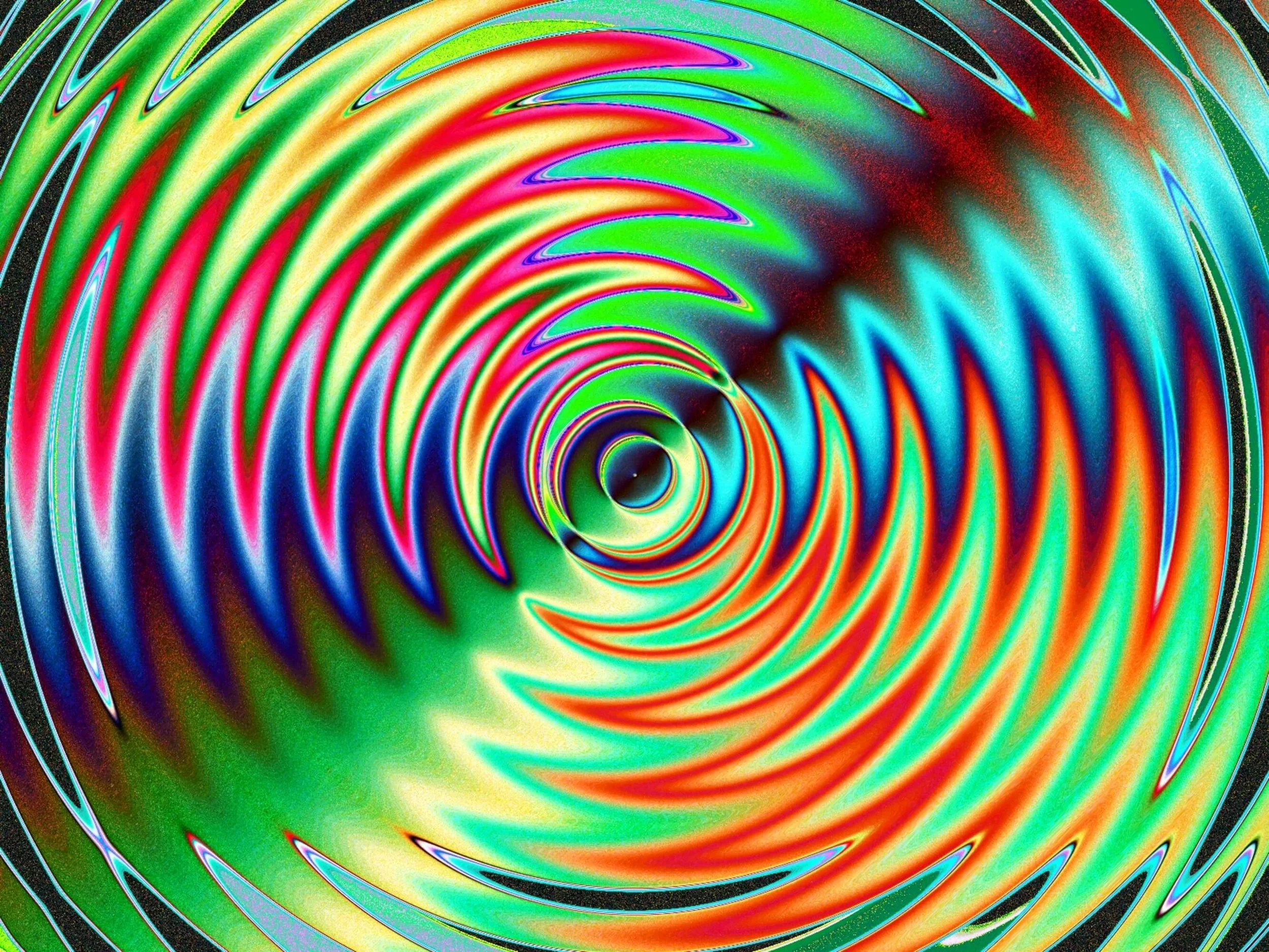 Colorful abstract spiral with vibrant red, green, blue, and yellow patterns.