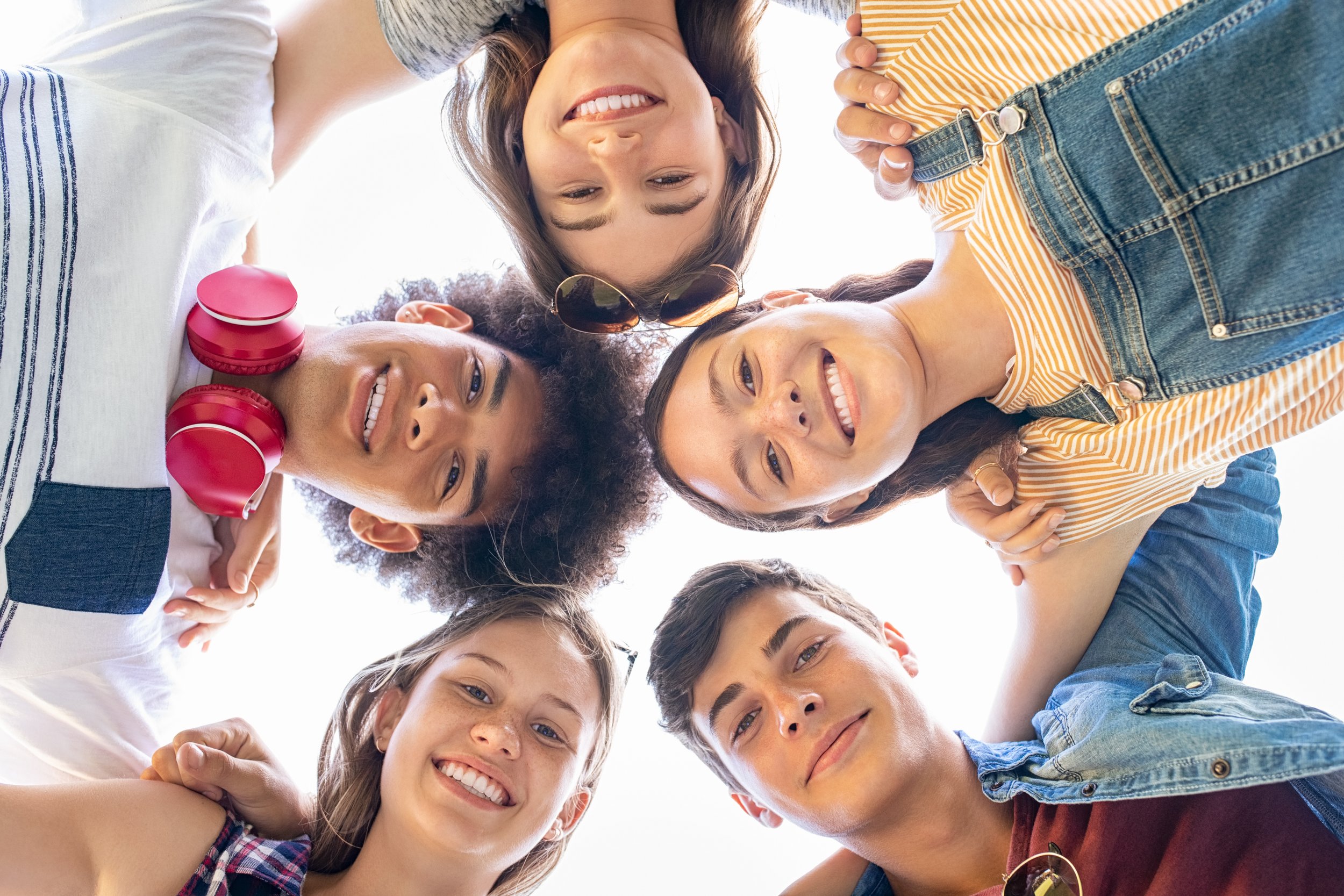 Smiling #social #teen #group looking down heads in a circle