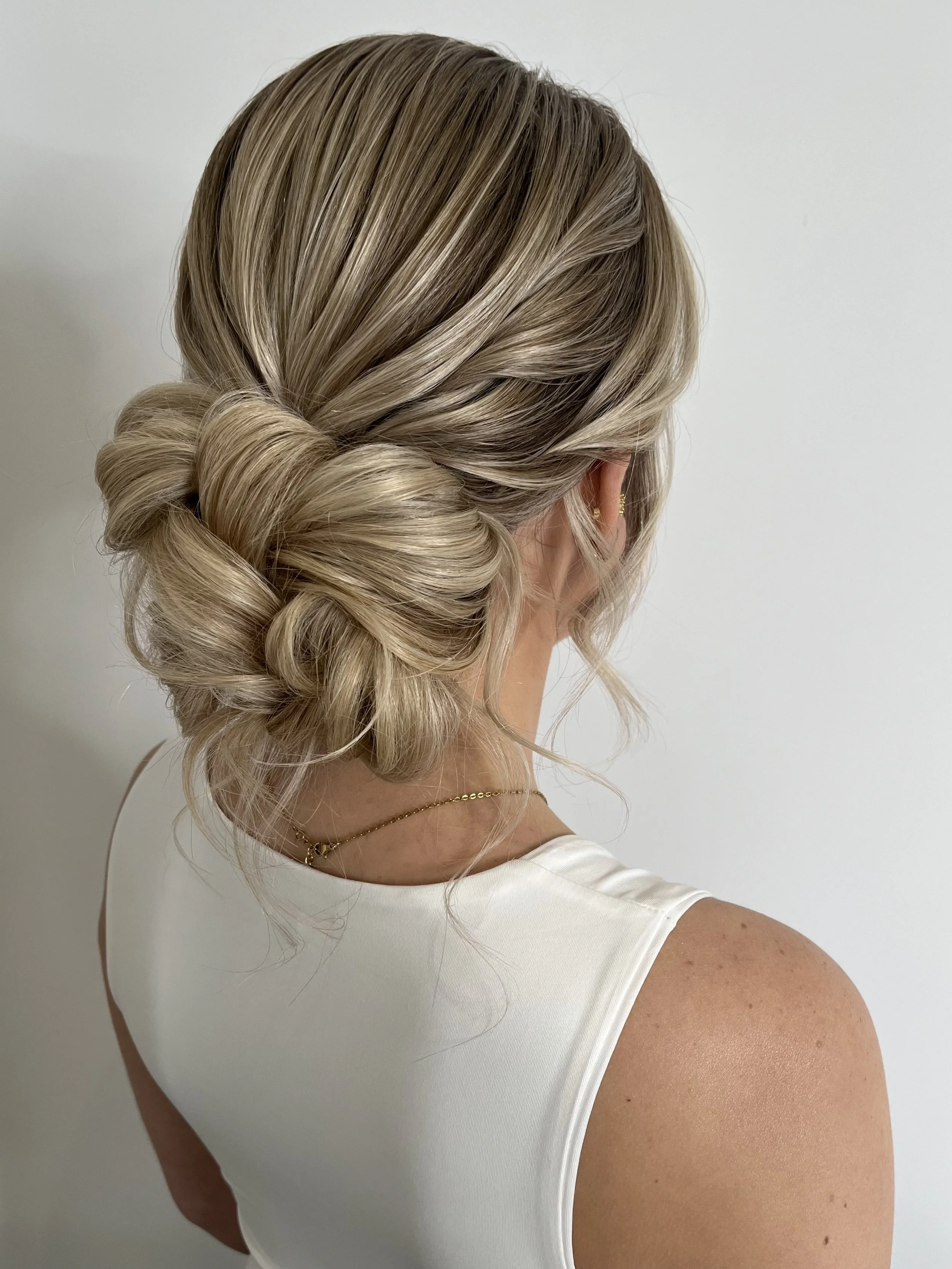 Tutorial video- Low bridal textured updo with a sleeker crown and twisted detail