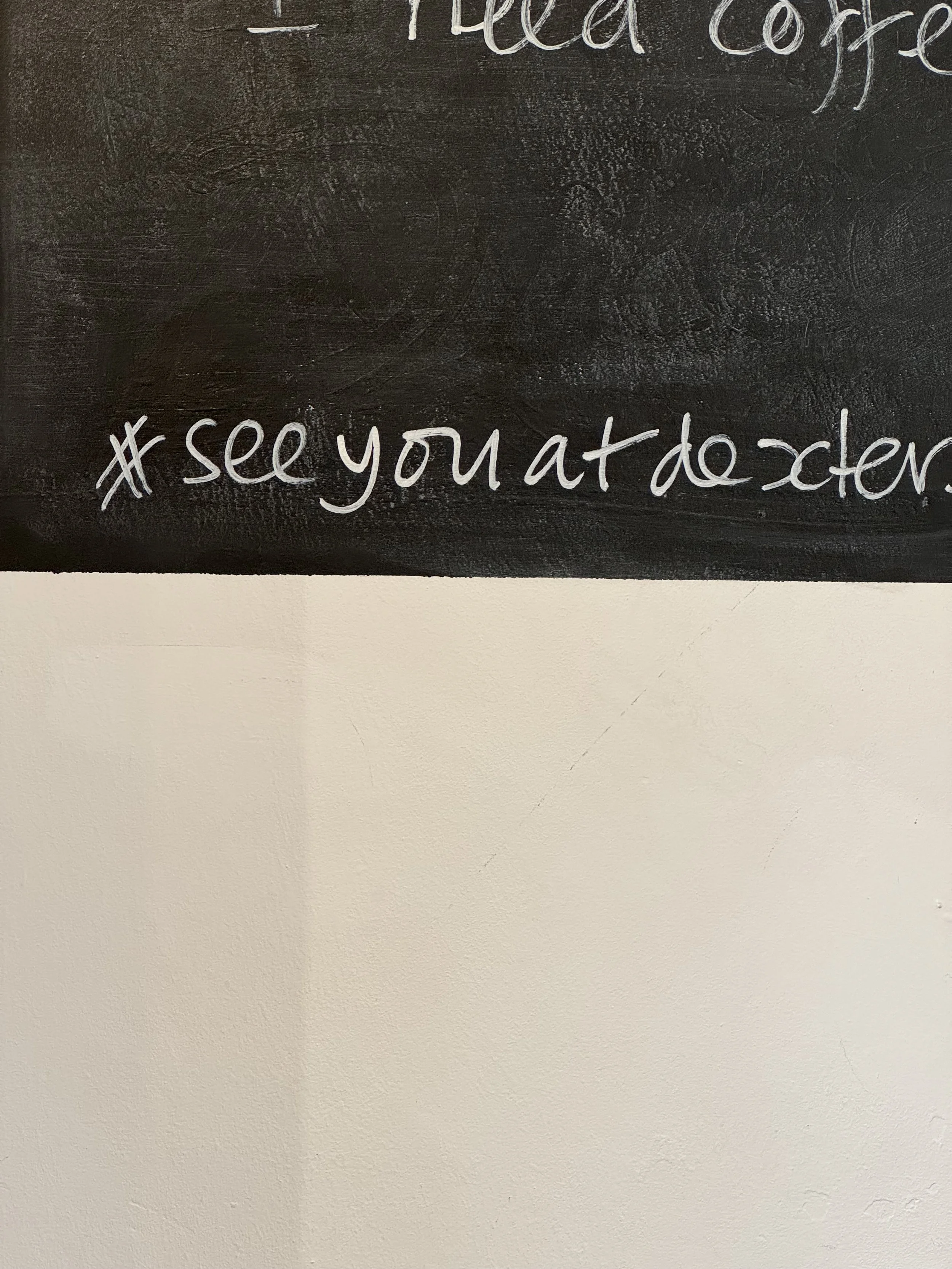 Blackboard with the hashtags #seeyouatdocter written in white chalk.