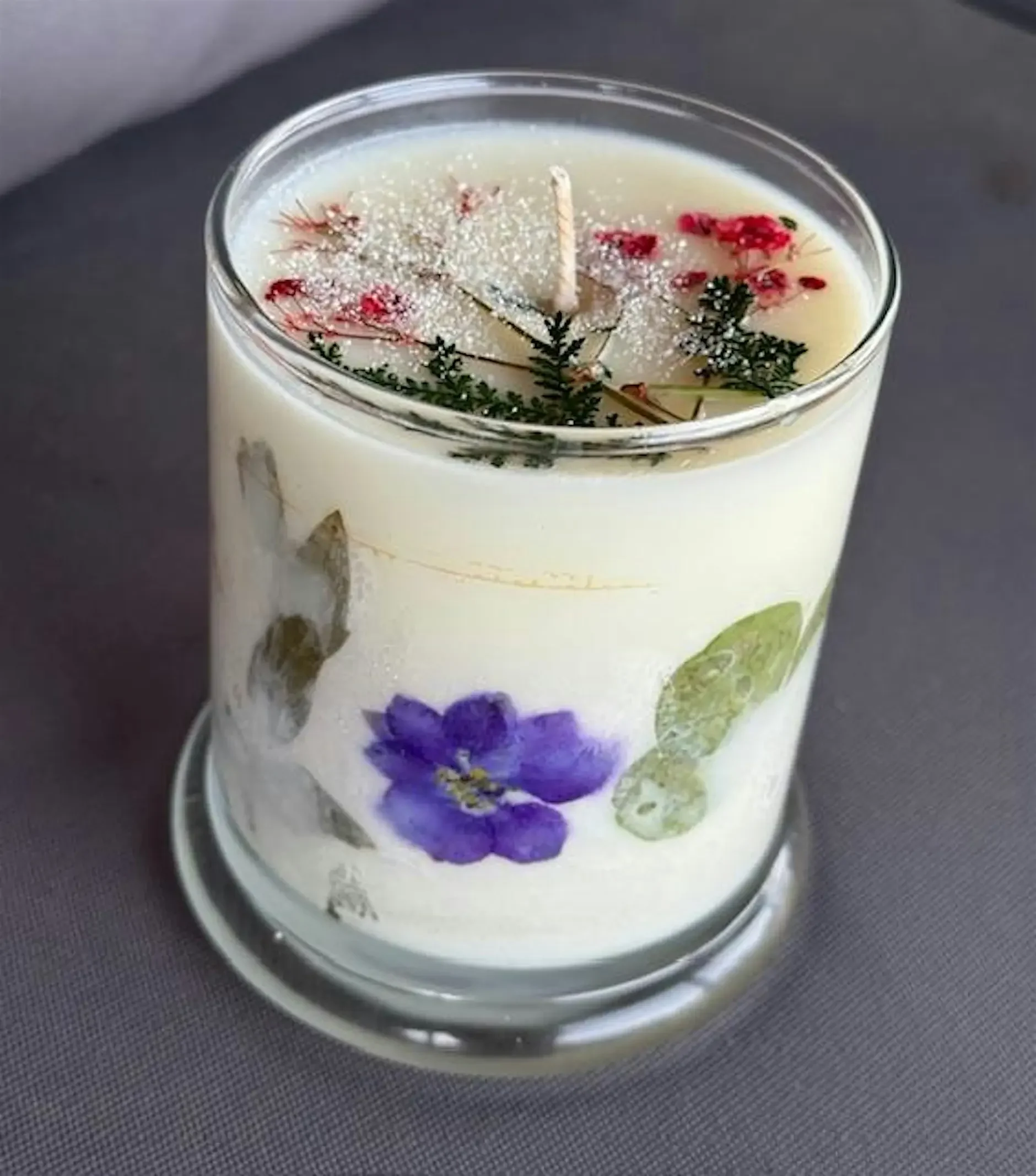 Hand-poured floral candle with herbs and botanicals at Denver Mother’s Day market
