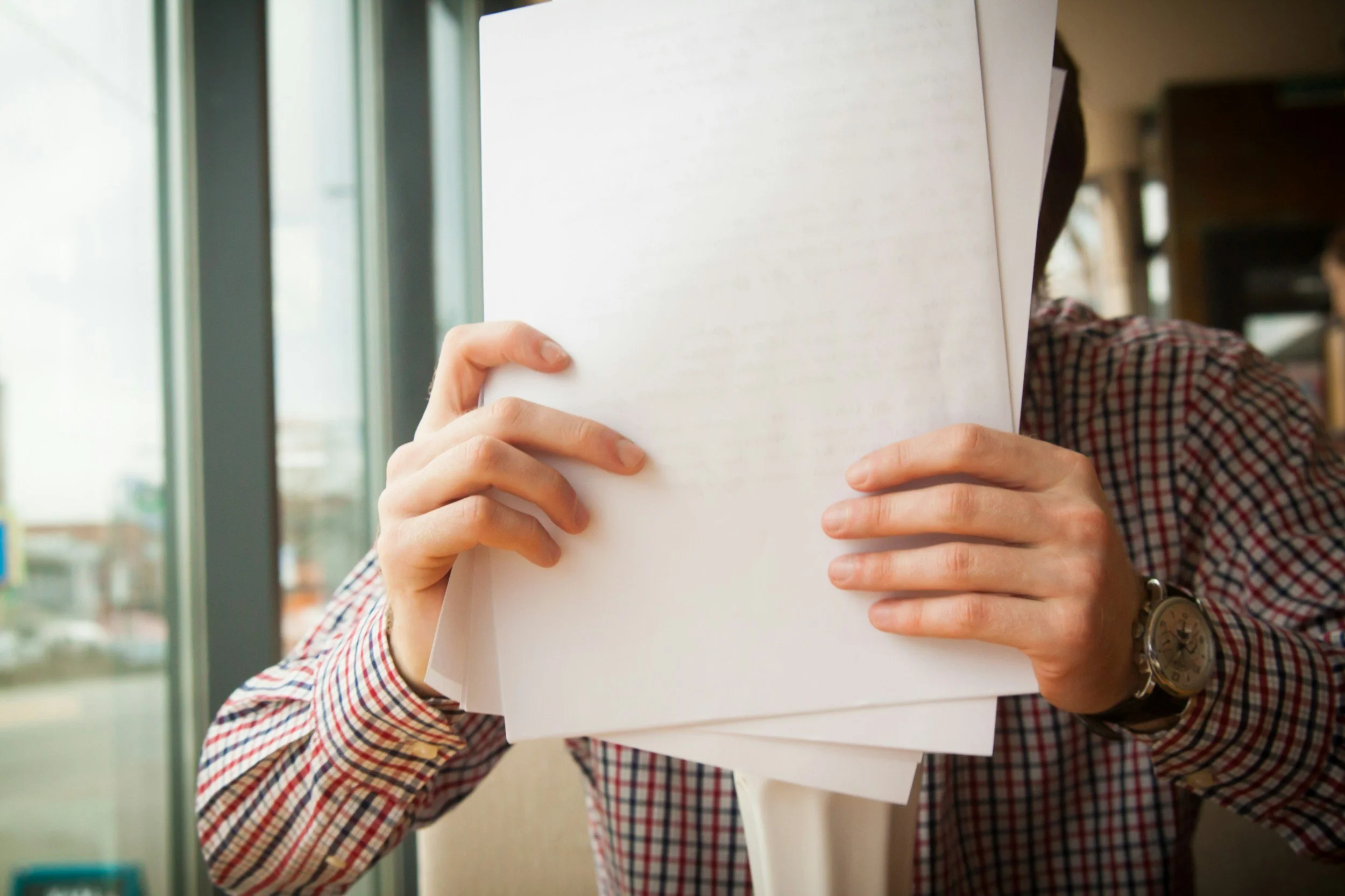Person holding grant proposal in hands.