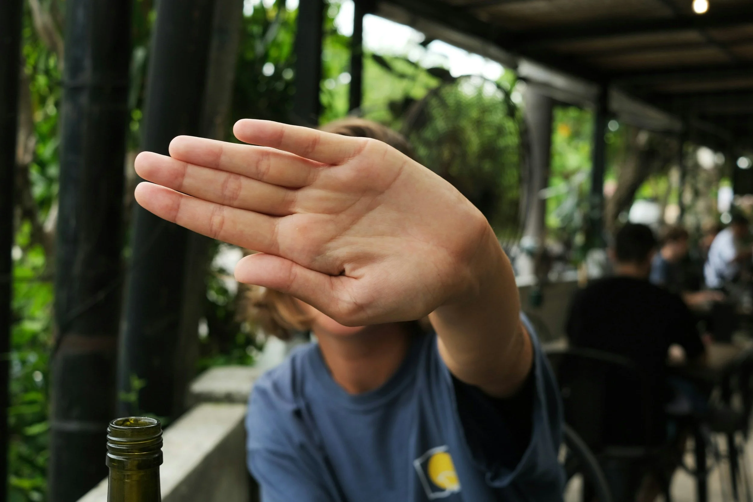 Person holding a hand up to the camera in a stop gesture, representing declining a grant opportunity without damaging the relationship