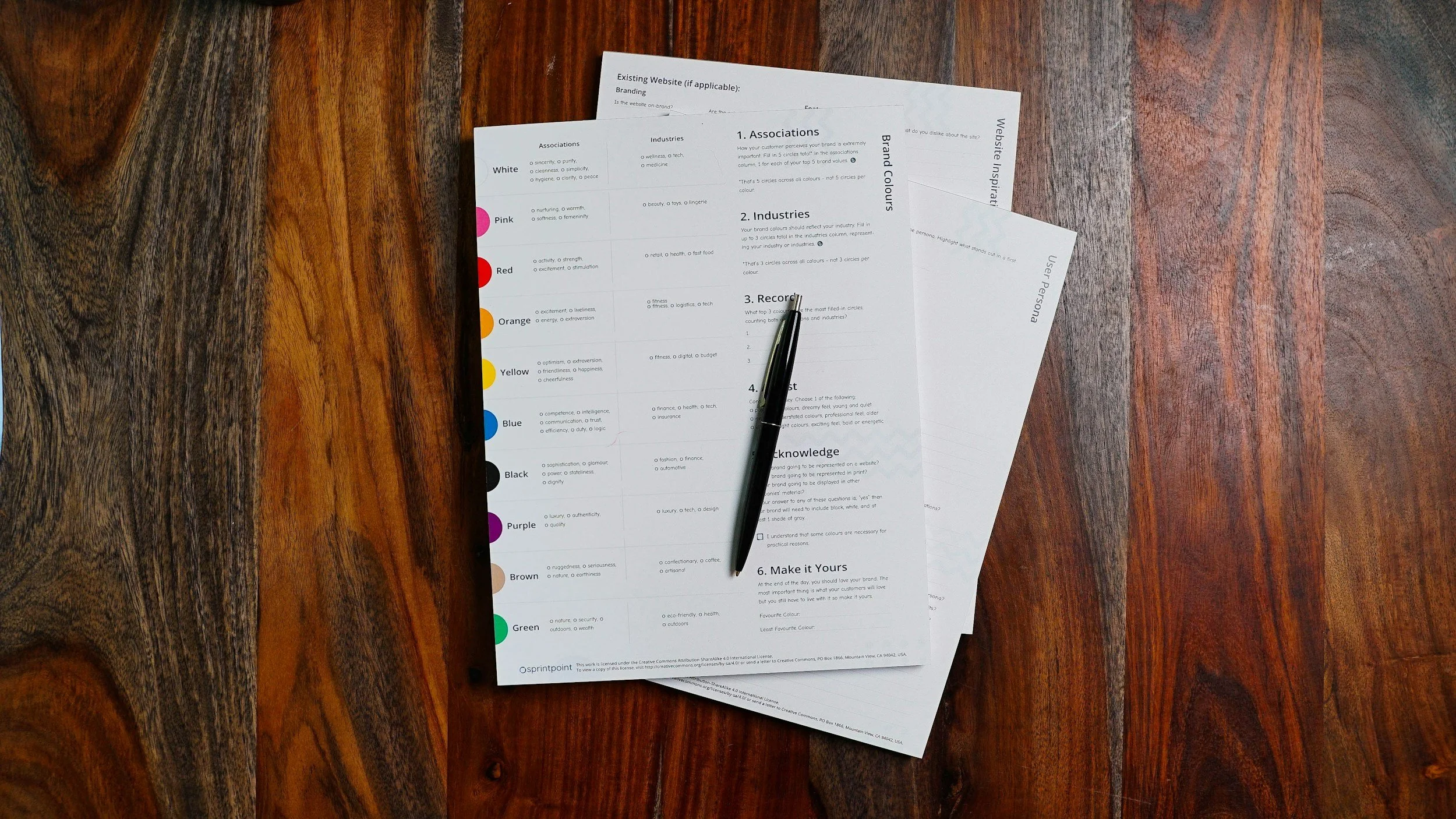 A paper survey form on a table with a pen resting beside it.