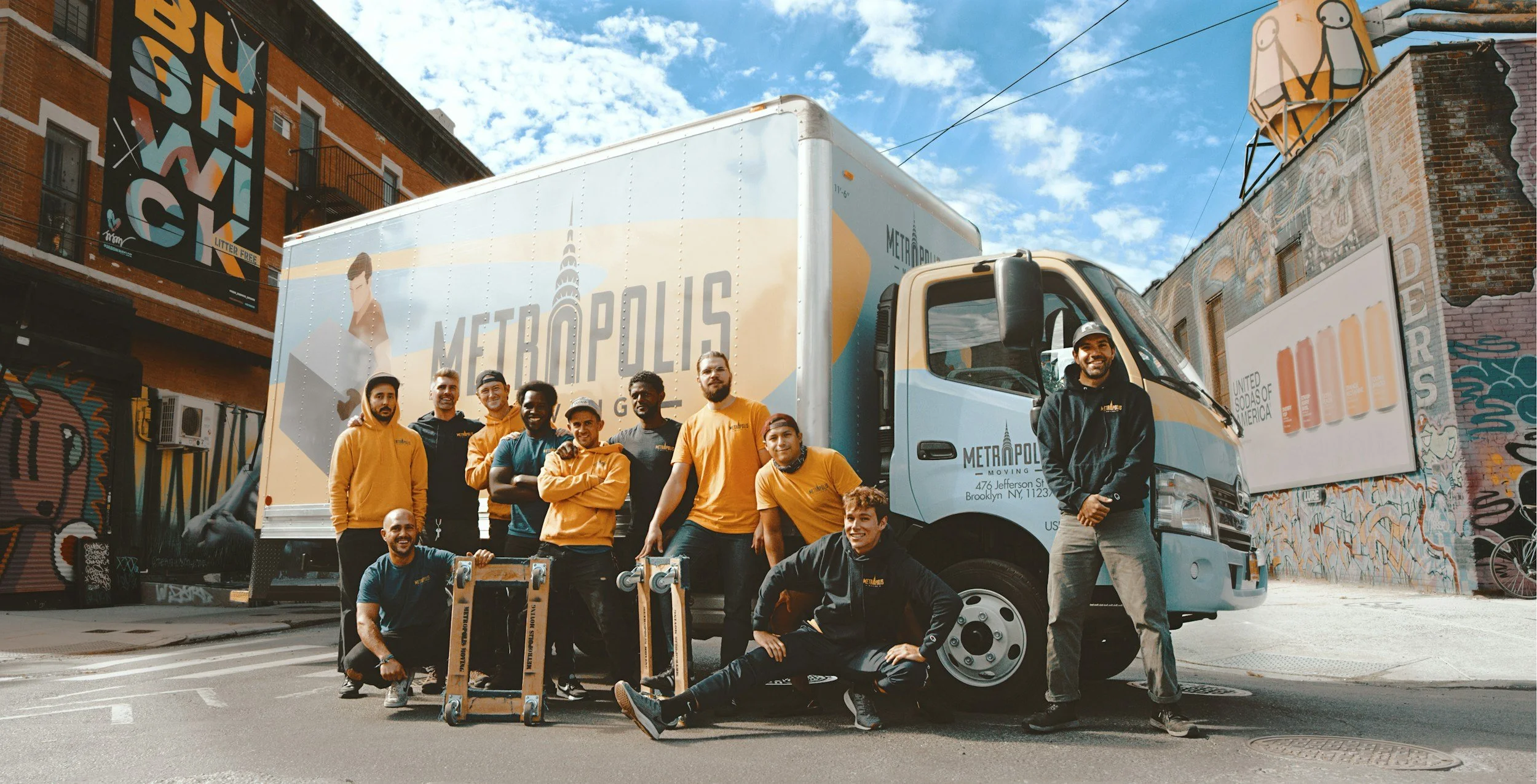 eople unloading furniture from a box truck.