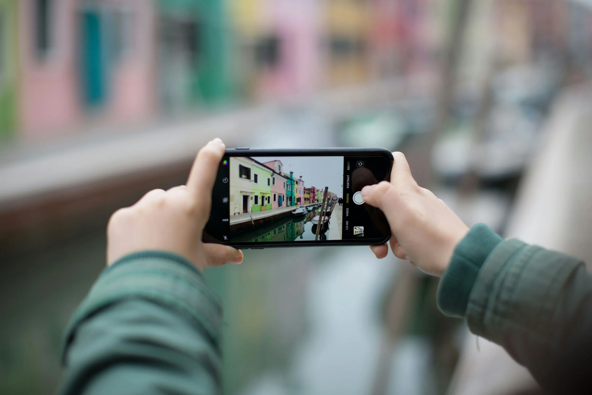 A person taking a photograph with their cell phone.
