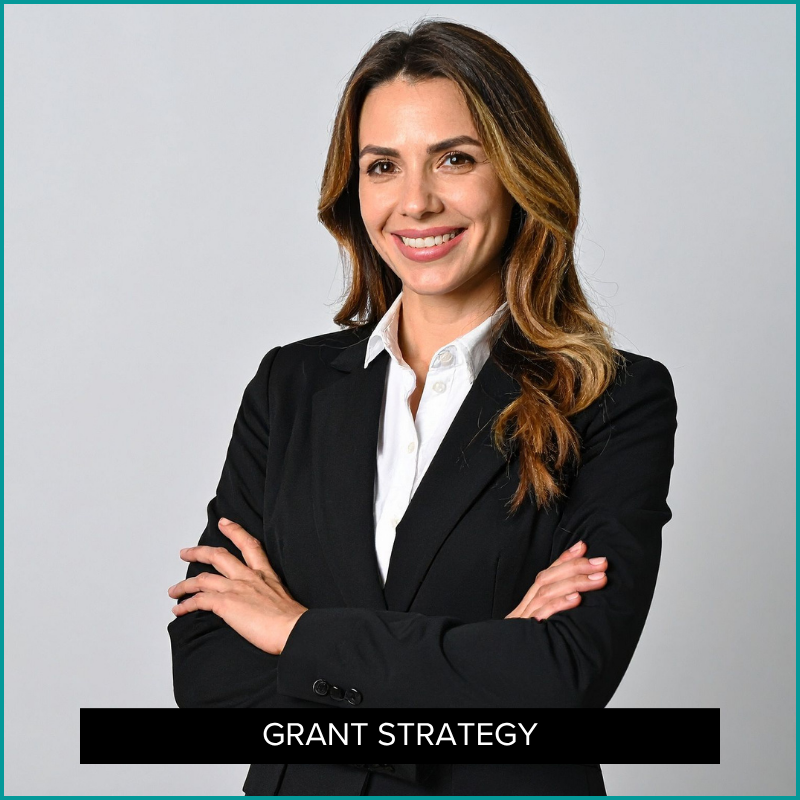 Woman standing confidently in suit.