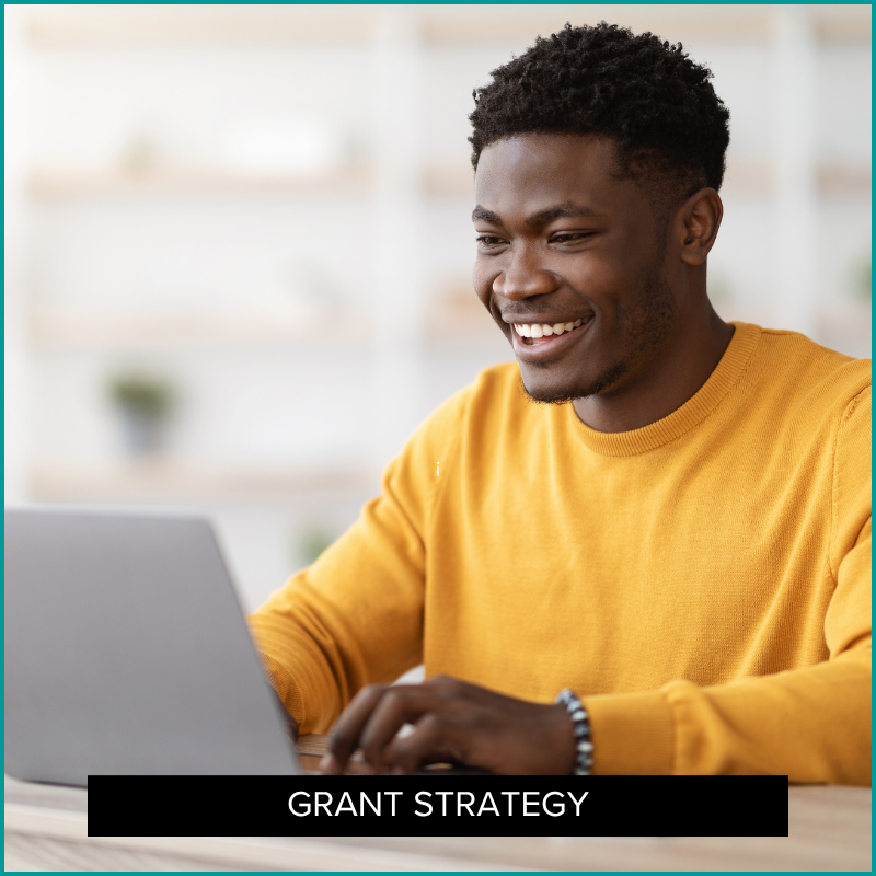 grant writer smiling as he writes a letter of interest
