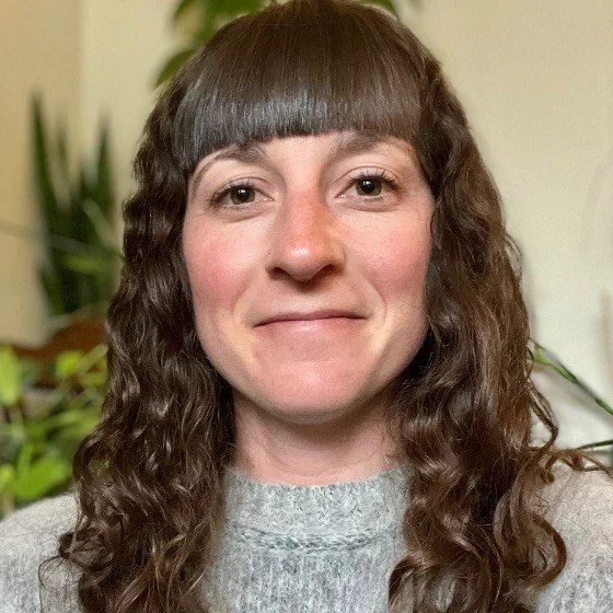 Smiling grant writing student with brown hair.