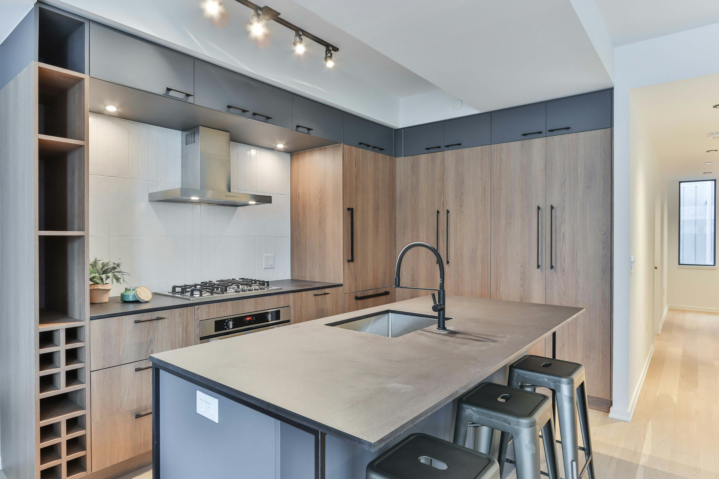 Open concept kitchen remodel featuring a large center island after a structural wall removal in Ottawa