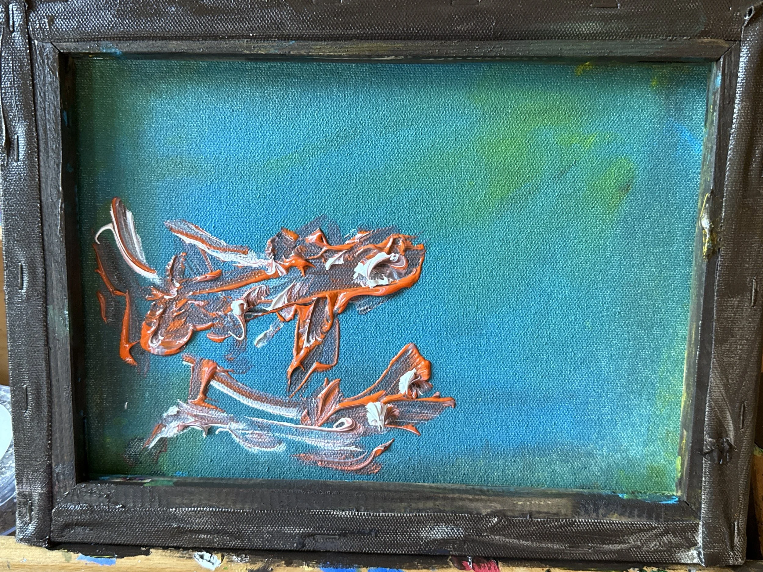 Abstract acrylic painting on small canvas, featuring thick orange, white, and brown strokes on blue-green background, framed with black frame.
