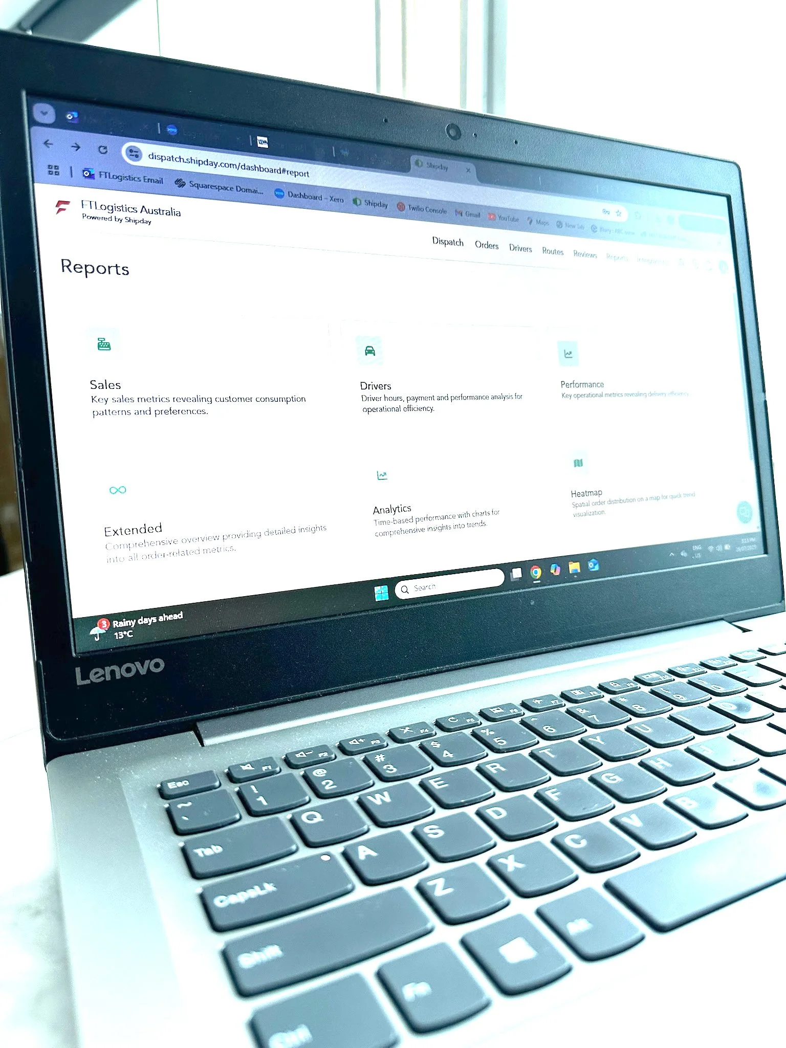 Lenovo laptop displaying the FTLogistics Australia dashboard with reports on sales, drivers, performance, extended analytics, and heatmap.