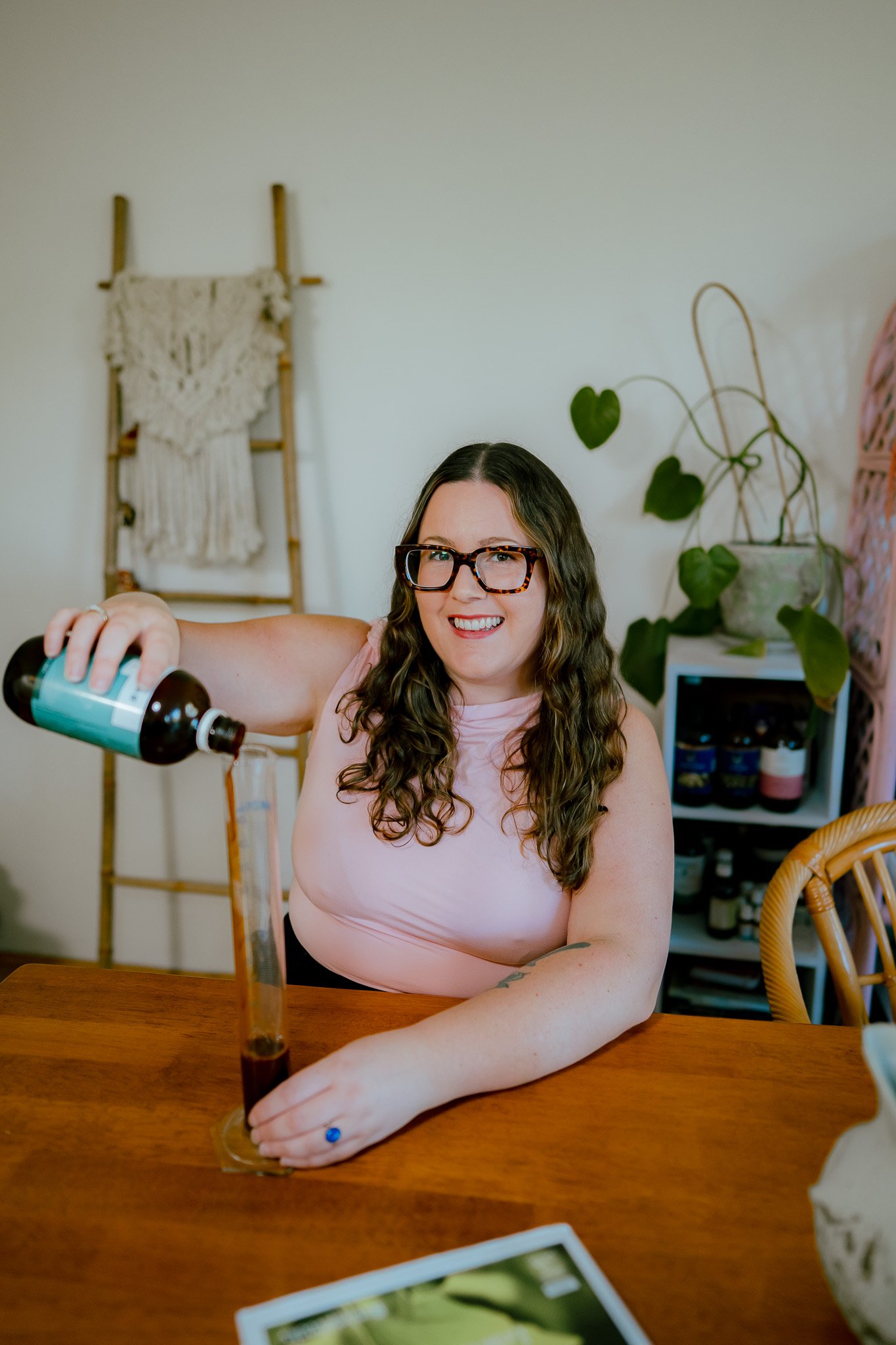 Founder of Botanical Abundance Jessie-Anne Naturopath pouring herbal medicine