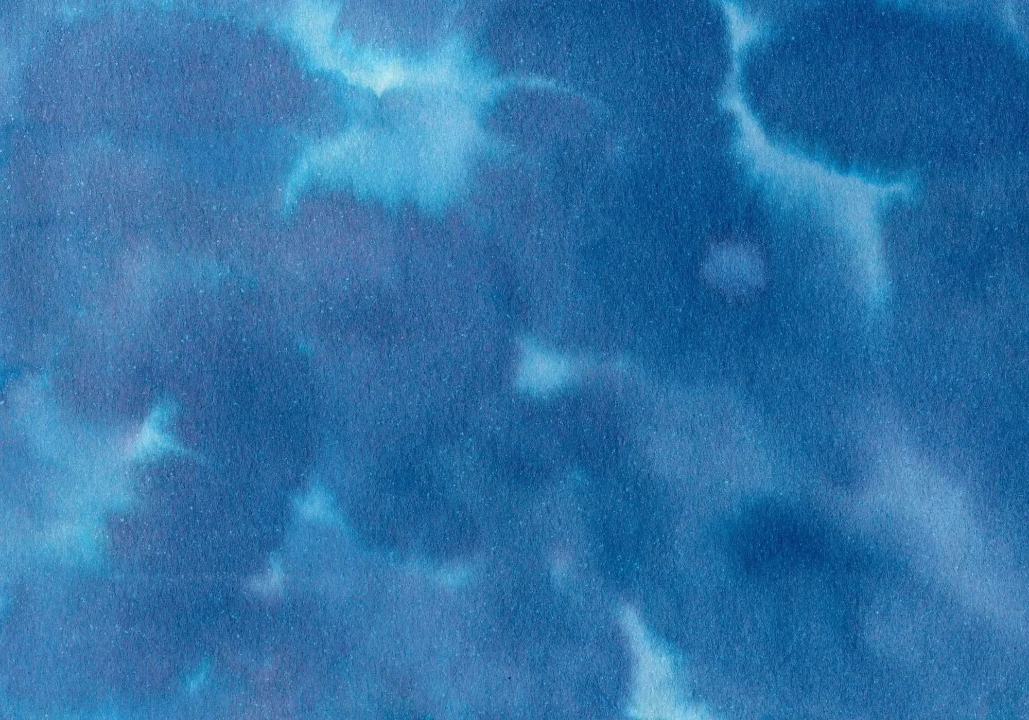A close-up of a blue, slightly cloudy sky with visible stars, creating a celestial appearance.