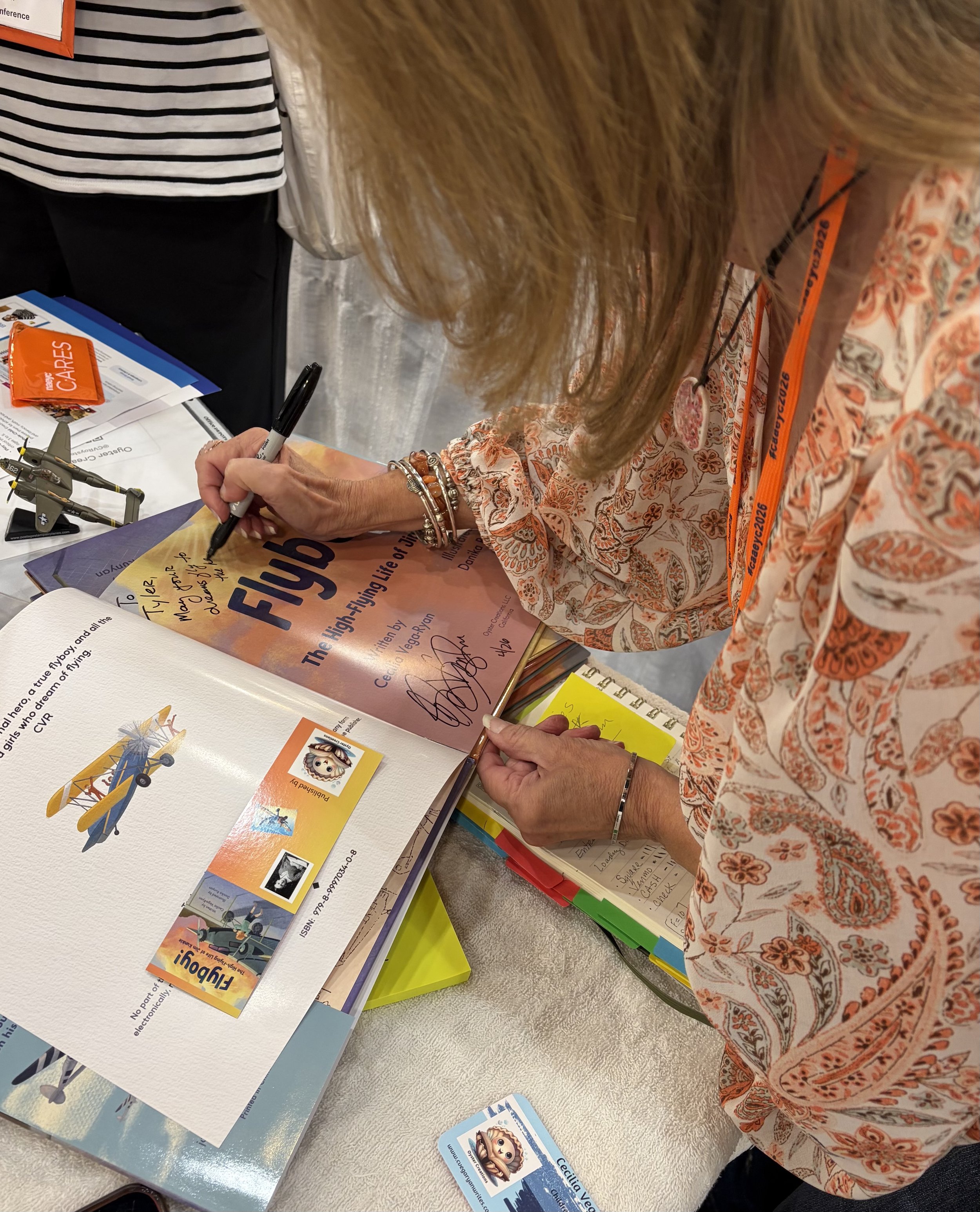 Signing books at CAEYC Conference
