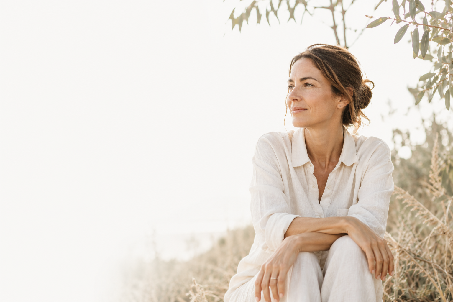 woman sitting in nature smiling