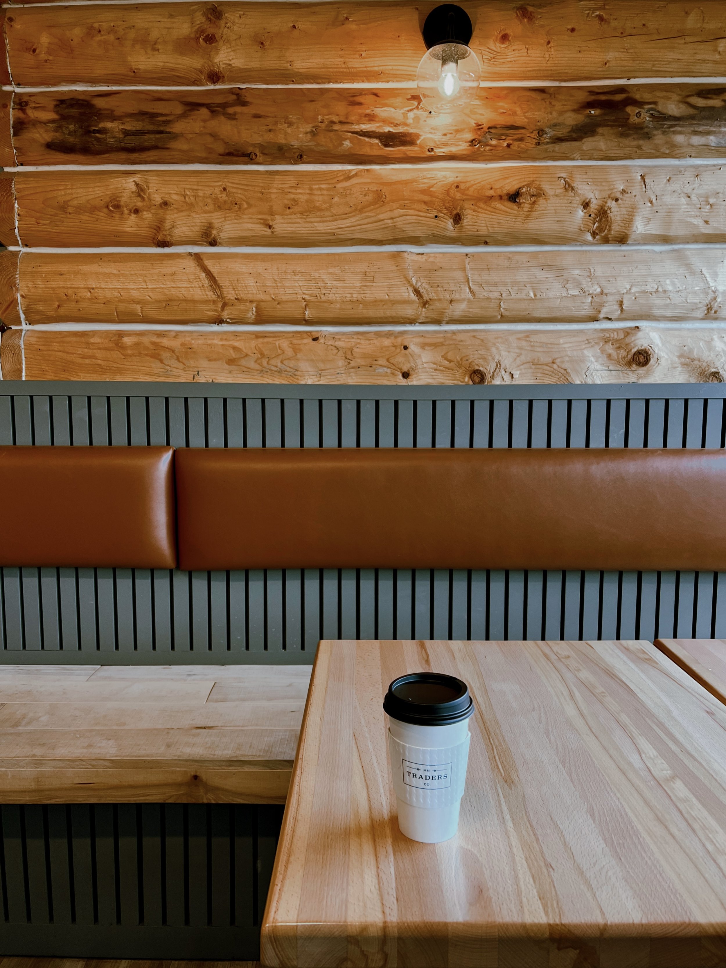 Naomi Goff brand designer lifestyle photo with coffee cup and wooden backdrop