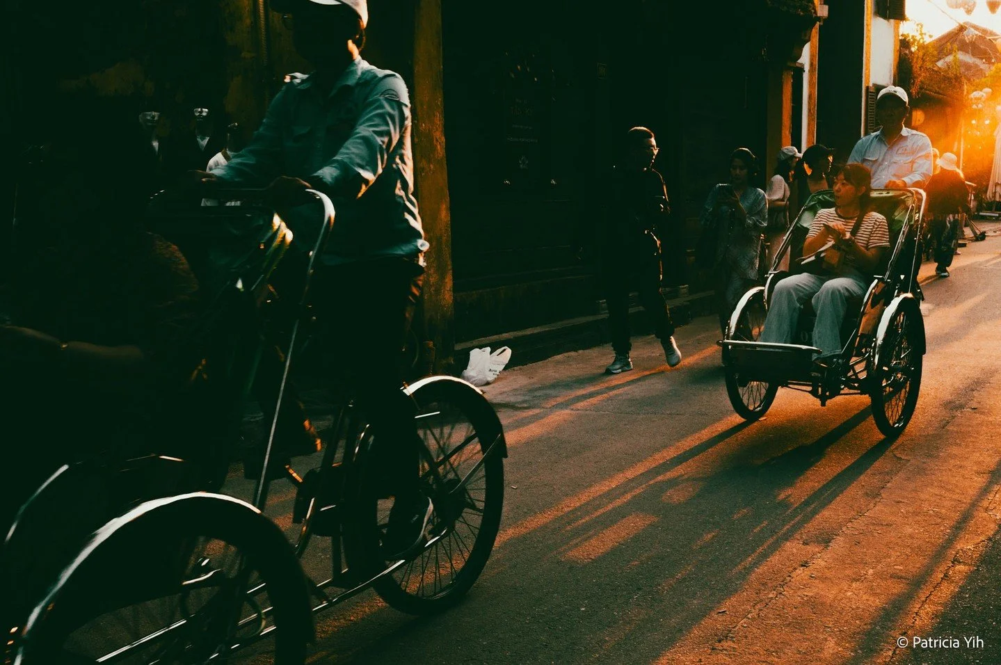 Golden light dances through the streets of Hoi An, capturing the charm of trishaw riders and their passengers as they glide through the historic town. This timeless moment, framed with the Leica M11-P and Leica 35mm f/1.4 Summilux-M ASPH, showcases t