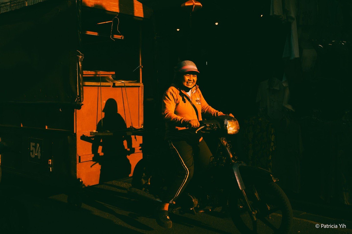 Golden light casts long shadows as a Hoi An street vendor rides through the bustling streets, her warm smile radiating joy. Captured during the golden hour, this moment reflects the vibrant and resilient spirit of Vietnam. Taken with the Leica M11-P 