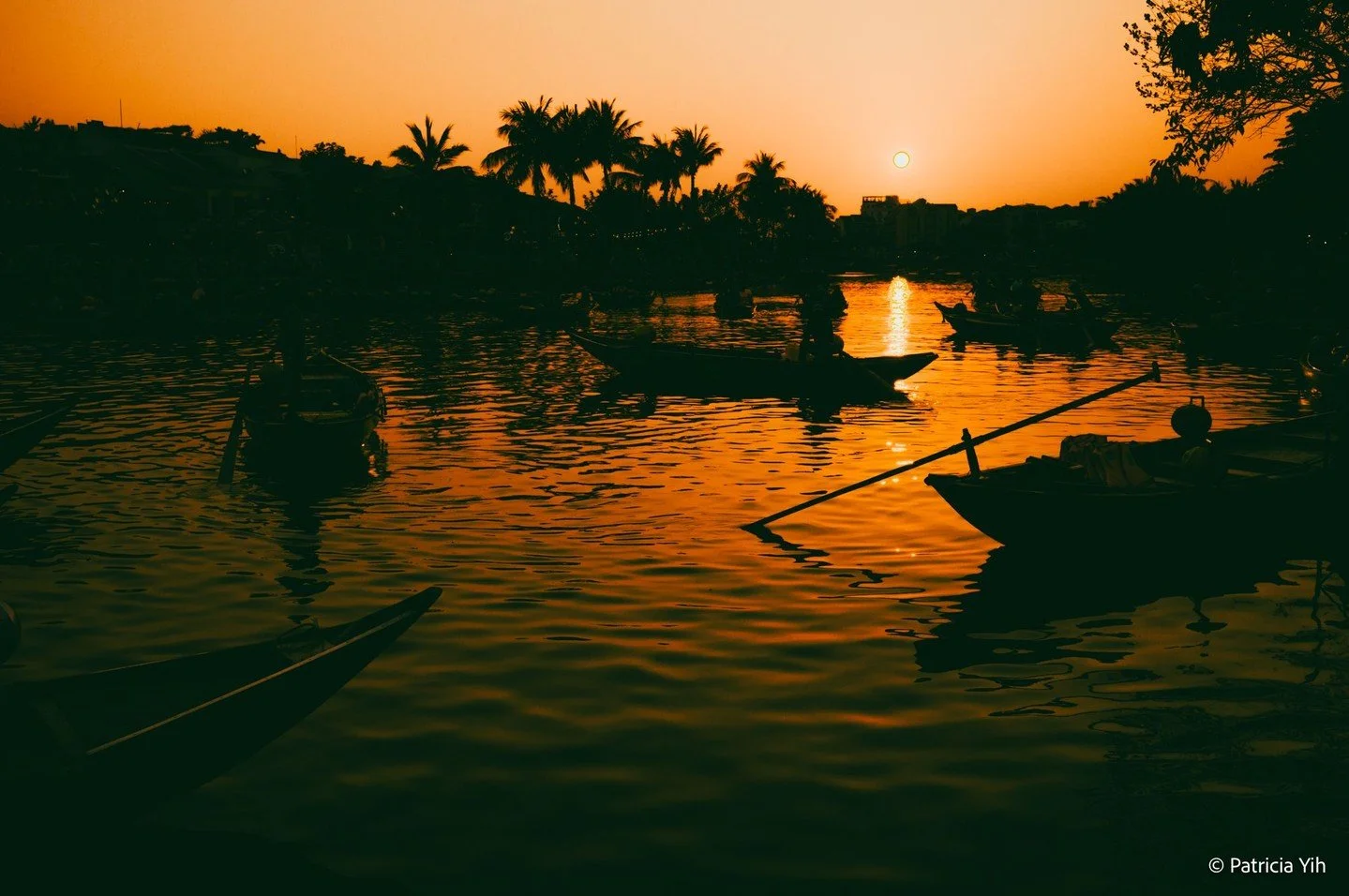 Golden hues reflecting on the water, a peaceful journey unfolds along the river. This serene moment captured in the historic charm of Hoi An, Vietnam, highlights the timeless connection between man and nature. Taken with the Leica M11-P and Leica 35m