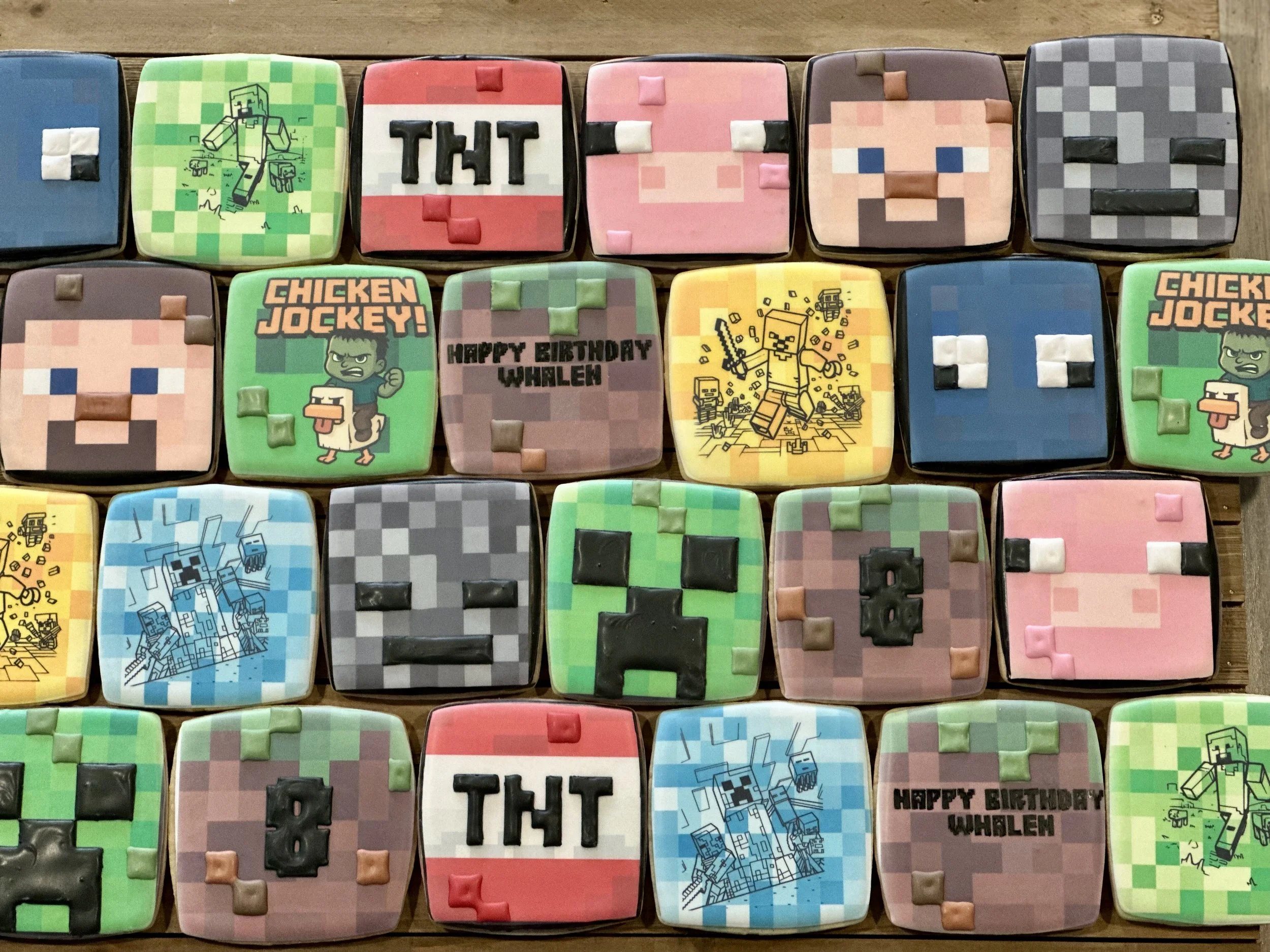 Decorated cookies with Minecraft theme, including characters, blocks, and phrases like "TNT."