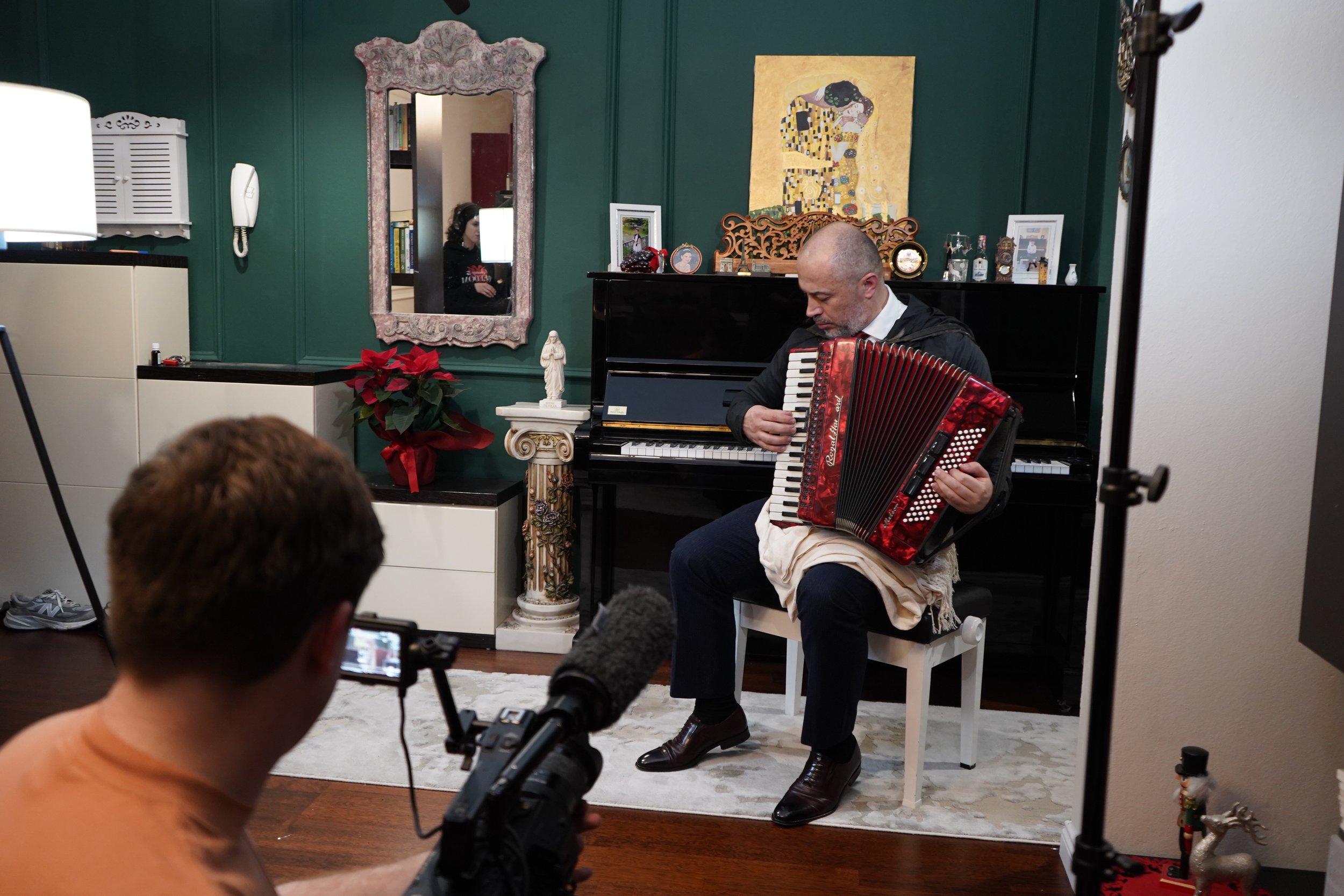 Avenir Lleshanaku playing the accordion. He was forced to play this instrument during Albanian communism.