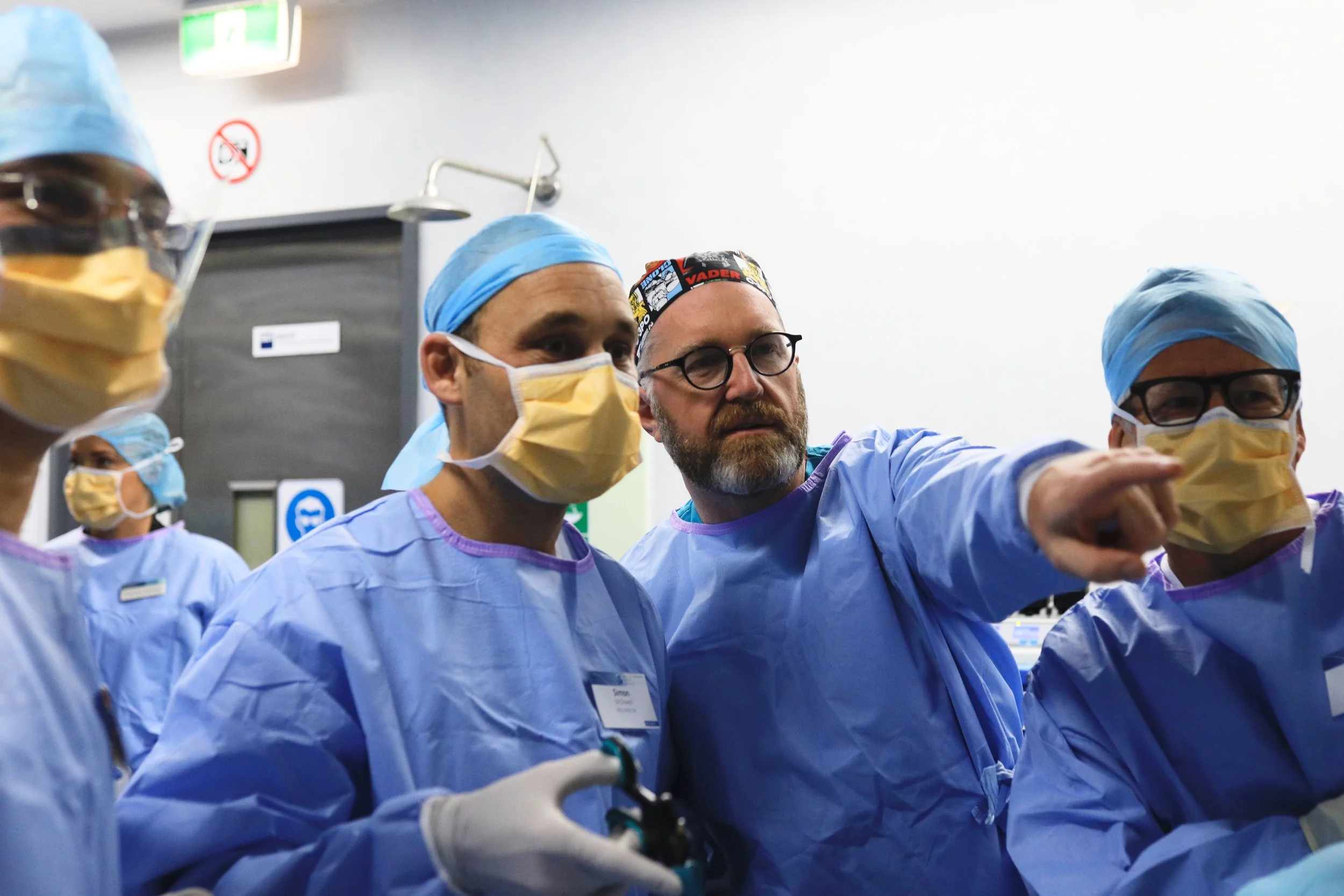 Dr Michael Wynn-Williams with surgical team performing laparoscopic procedure in operating theatre