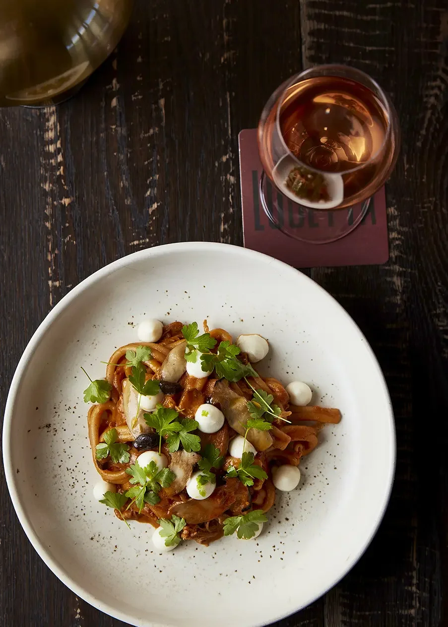 pasta and wine on a wooden table at lucetta