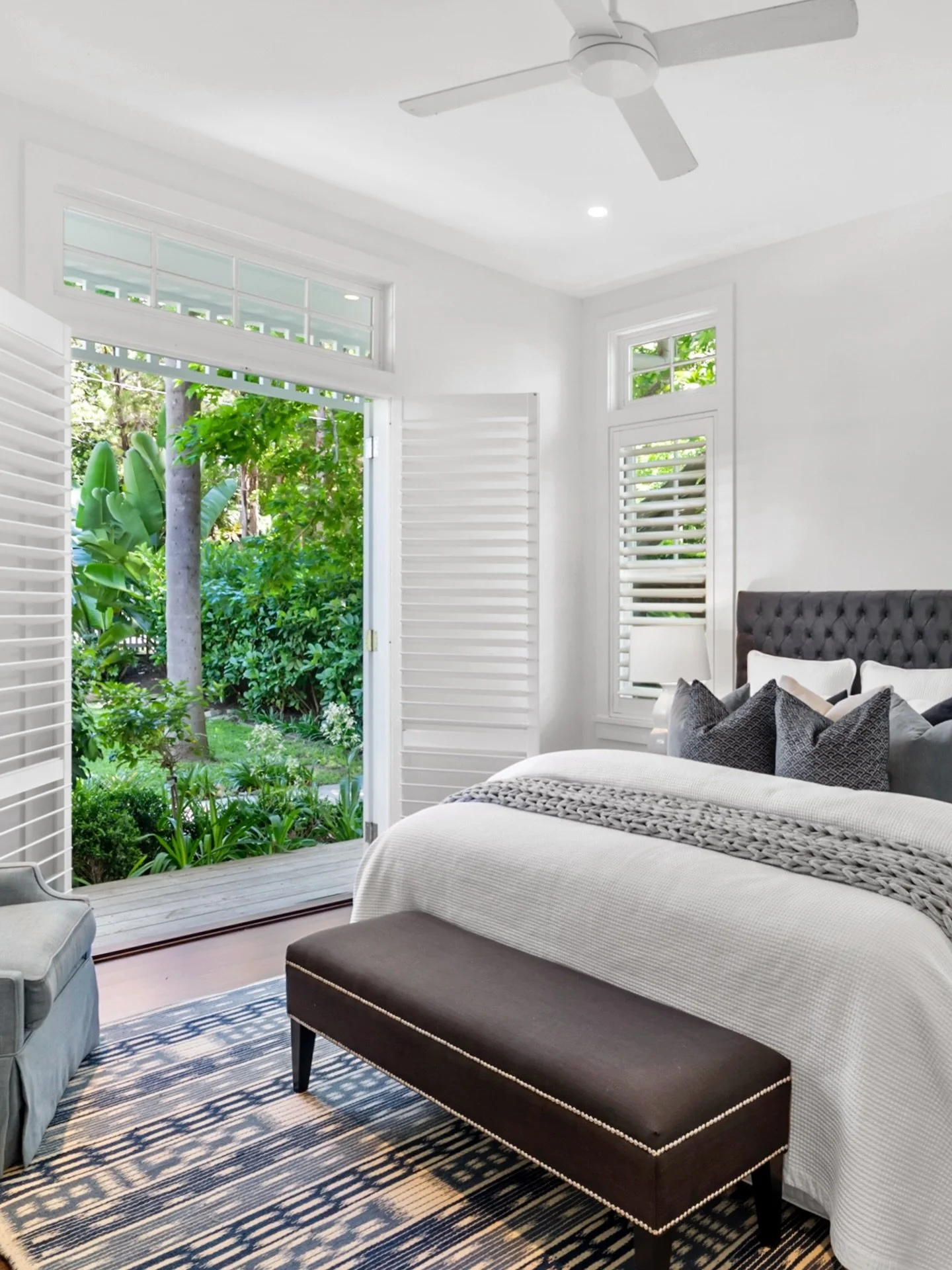 Letting the outdoors in comes naturally in this Avalon Beach bedroom. French doors and plantation shutters open wide to create a seamless connection between indoors and out. Project @strittdesignandconstruction. #coastalliving #avalonbeachhouse #stri