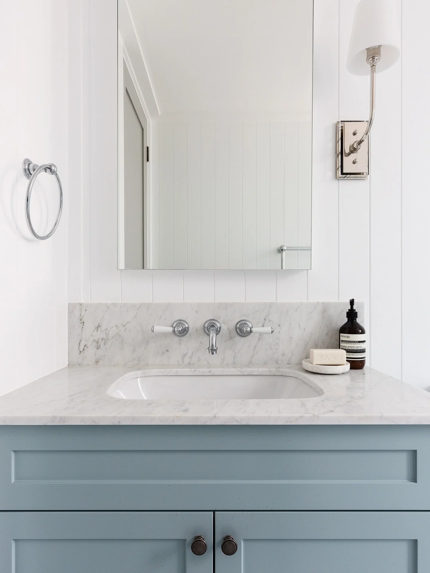 Clean and classic with a touch of blue for this guest ensuite. The built-in mirrored cabinet creates additional storage, perfect for compact bathrooms and a decorative shower window allows for filtered natural light and fresh air to enter the space. 